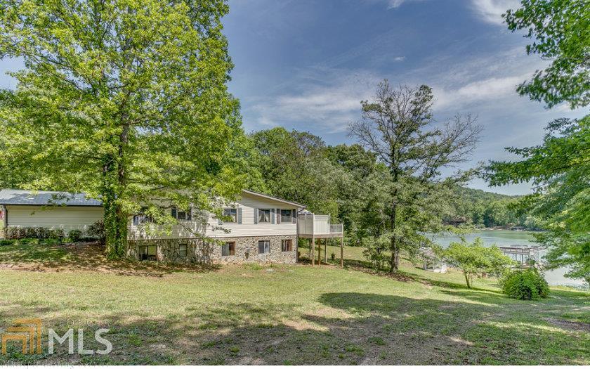 DEEP WATER, YEAR ROUND 4BR/3BA LAKE FRONT HOME. ONE OF THE MOST LEVEL DEEP WATER LAKE LOTS YOU WILL FIND. OPEN FLOOR PLAN WITH GREAT ROOM, KITCHEN & DINING AREA. LARGE FIREPLACE, HARDWOOD FLOORS, OPEN KITCHEN WITH SOLID SURFACE COUNTER TOPS, LOTS OF CABINET SPACE & PANTRY. WET BAR, STUDY, LARGE MASTER BR ON MAIN. FINISHED MOTHER IN LAW SUITE ON LOWER LEVEL, WITH FIREPLACE, OPEN FLOOR PLAN, BEDROOM & BATH. GARAGE ON MAIN LEVEL & LOWER LEVEL. HUGE TREX DECK, GAZEBO, LARGE YARD WITH STONE WALL BORDER, TWO STORY BOAT DOCK. ALL PAVED ROADS, HIGH SPEED INTERNET.