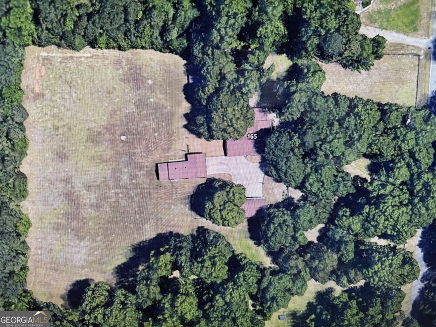 Two parcels being sold together for a total of 5.34 acres. - 165 Shamrock Drive & 175 Shamrock Drive One lot is 2.87 acres which includes a 2,537 SF house, 1,200 SF workshop, a horse barn and storage shed; Second lot is 2.47 acres  This 3 bedroom/2 bath ranch is located 1.5 miles from Sara Minter Elementary and 1.7 from highly sought-after WHITEWATER HIGH SCHOOL. This is truly a beautiful 5.34 acres with all hardwood trees and a back pasture. This ranch has an open floor plan with a large all-season sunroom. It includes a large master with ensuite bath and oversized walk-in closet. The house needs some updates but has tremendous potential. The workshop is 1,200 SF and has power and water. The horse barn has stalls for 4 horses also has power. The peaceful surroundings offer a country setting along with convenience and the best schools. No HOA but very close-knit neighborhood. Taxes reflect a senior discount.  Presale appraisal completed on both properties.