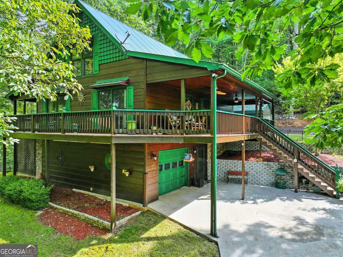 Escape the hustle and bustle and enjoy the peace of mountain living in this immaculate 3BR/3.5BA cabin, perched at 2,400+ ft in beautiful Fannin County. Designed for both comfort and nature, the home offers breathtaking year-round views from every room, with walls of glass bringing the outdoors in. Each level features a bedroom and bath for privacy, including a terrace-level suite, while the main level includes a half bath for guests. Ample parking with garage, carport, and level driveway access. Whether a full-time residence, weekend retreat, or income-producing rental, this well-built mountain fortress is adaptable to your needs.