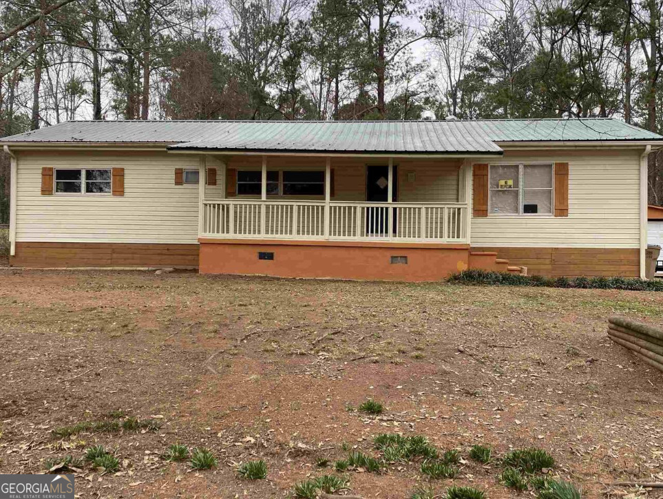 Seasoned single-story home ready for a negotiable cash buyer in Henry County. This open-concept home is in move-in-ready condition and features LVP (luxurious vinyl plank) flooring and modern kitchen cabinets. The kitchen also features a standalone butcher block countertop a separate island that can also be used for dining with the addition of chairs. Appliances are stainless steel, and recessed lighting brightens the entire area. The home has excellent fixtures and many other upgrades. The front porch offers a quiet getaway for entertaining or sitting and relaxing your mind after a busy day. The rear porch is screened and overlooks a flat, fenced-in backyard. The home has a detached garage with electricity and a workshop. Cash Buyer Only. Sold "As Is" with no disclosures or warranties. Agents, please read Private Remarks. Please feel free to call or text with questions. Please call the listing agent to schedule showings.