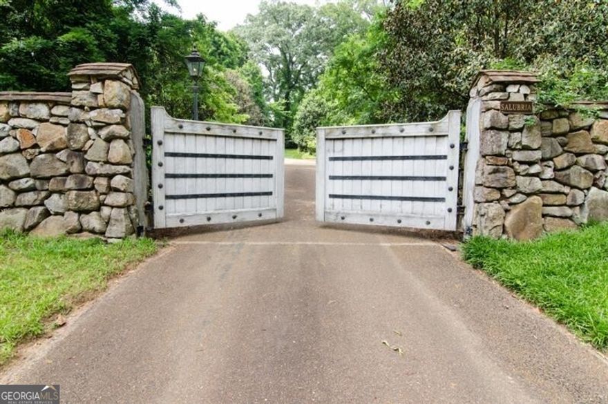 Nestled on one of Buckhead's largest building sites, this extraordinary 15-acre property boasts a stunning European-style, three-story guest house crafted from Jerusalem stone. With expansive views of the Chattahoochee River and situated at one of Atlanta's highest elevations, this property offers unparalleled beauty and privacy. The spacious guest house is ideal for comfortable living or construction office space while you plan and build your dream estate. A winding, stone-lined driveway, surrounded by lush, mature landscaping, leads you to the highest point of the property, where your vision can become a reality. Perfect for a grand estate or an equestrian enthusiast, this secured, gated property is available by appointment only.