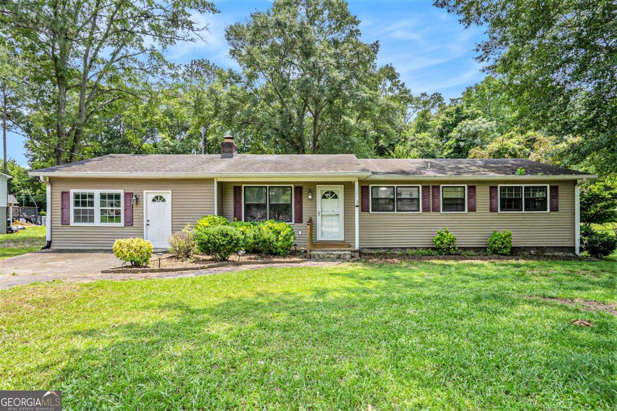 Charming Ranch in the Heart of Hiram! Tucked in a quiet, established neighborhood with mature trees and landscaping, this 3-bedroom ranch offers space, potential, and a fantastic location close to downtown Hiram. The original carport or garage has been enclosed, creating a spacious bonus room-perfect for a playroom, office, or even the start of a future primary suite renovation. Inside, the galley kitchen connects to a separate laundry room and opens to a large family room with a classic brick fireplace. Step outside to a screened porch, a deck, and a generous fenced backyard ideal for pets, play, or gatherings. The inground pool needs a new liner but could be a great asset for outdoor living. This home is ready for your personal touch-come make it your own!