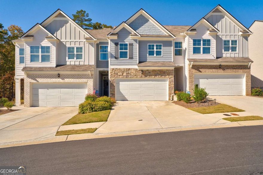 Hands down the best price in Mountain Park! This lightly lived-in, turn-key, move-in-ready townhome truly has it all.  Step inside to an inviting, open-concept living and dining area highlighted by a radiant fireplace-perfect for cozy evenings. The chef's kitchen features granite countertops, a subway tile backsplash, a large island, a pantry, and all stainless-steel appliances, plus a washer and dryer included for your convenience.  Just outside is a private fenced yard and porch perfect for grilling and morning coffee.  Upstairs, the spacious primary suite offers a luxurious bath with a separate soaking tub and shower, double vanities, and generous closet space. Two additional bedrooms, a full bath, a flexible office or lounge area, and a storage closet complete the comfortable layout.  Enjoy access to fantastic community amenities including a pool, fitness center, and clubhouse. Ideally located just a minute from Historic Downtown Dahlonega's charming shops and restaurants, with easy access to GA 400, North Georgia wineries, Amicalola Falls, horseback riding, biking trails, and more-this home offers the perfect blend of comfort, style, and convenience.  Don't miss this opportunity-the best value in Mountain Park won't last long!