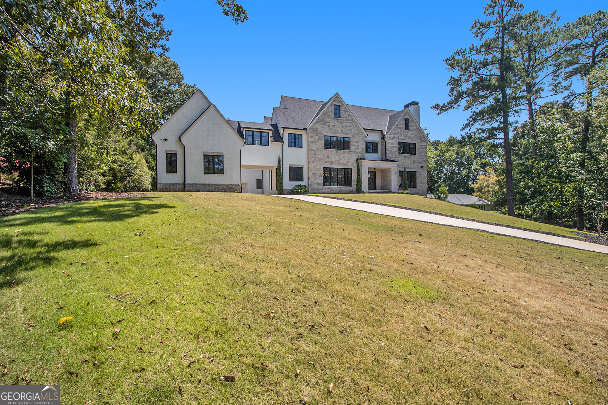 This is the one you've been waiting for! Beautifully built and thoughtfully designed, this 6 bedroom/6.5 bathroom pristine home has everything you're looking for in a new home. Situated in the prestigious West Paces neighborhood, 2731 Ridgewood Rd embodies luxury and comfort from the moment you step inside. Main level features three fireplaces, luxurious guest en suite, grand dining room, dining hall and study, oversized windows that flood the space with natural light, all with beautifully detailed trim work to accentuate each room's elegance. Stainless steel Thermador appliances and a second kitchen/scullery elevates the culinary experience along with quartz countertops and backsplash. The second floor leads to the primary suite that boasts a separate media room that leads to a porch with a fireplace, additional fireplace in the bedroom, spa-like bathroom and massive walk-in closets you really must see to believe. Three generously sized bedroom en suites are also located upstairs, each with private bathrooms and walk-in closets, as well as a large bonus room perfect for a second office or playroom. The fully finished terrace level expands the living space with a cozy fireside living room, bar and billiard room. For additional comfort and entertaining this level features a theater room perfect for movie nights or watching your favorite sports, gym, wine room, private guest en suite and more. This area effortlessly transitions to the outdoor oasis, where a rock courtyard awaits. Other desirable home features include a 3-car attached garage and two-car detached garage, two mudrooms, an elevator and a pool ready for completion. Conveniently located near I75, I285 and Hwy 400, top-rated schools, fine dining, and shopping.