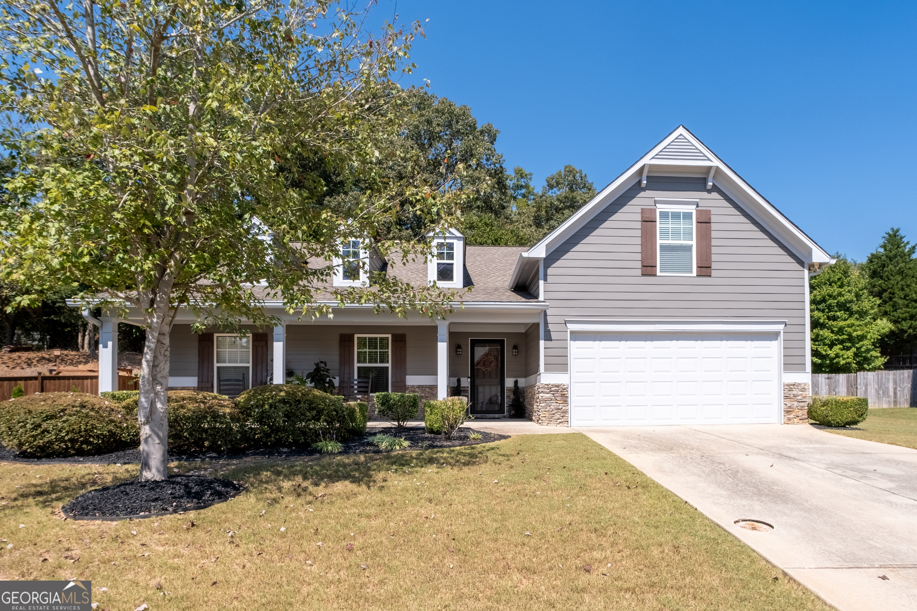 Welcome to 4458 Spring Mountain Lane! Hard to find functional Ranch Floor Plan with an abundance of space for the family on almost half an acre lot size! Over 2,500 square feet of character that has been meticulously maintained and ready for move-in. The foyer will welcome you to the main living space that has beautiful high ceilings in the living room, gorgeous NEW flooring throughout, and perfectly flows to the dining room and kitchen, where you'll find granite countertops, a walk-in pantry, and an additional bartop with a breakfast area. The main level features 3 guest bedrooms, a full bathroom, and a convenient walk-in laundry room. At the end of the hallway, you'll find the private, oversized primary suite complete with a luxurious en suite bathroom.Upstairs, a versatile space awaits-ideal as a playroom, home office, family room, or a fifth bedroom to suit your needs.The highlight of this home is the backyard-fully fenced, beautifully landscaped, and enhanced by mature trees. It's the perfect setting for hosting a cookout, relaxing, or watching the kids play. Around the corner from Kroger, Sprouts, Restaurants, and schools - this home offers tremendous value and is ready for you to make it your own!