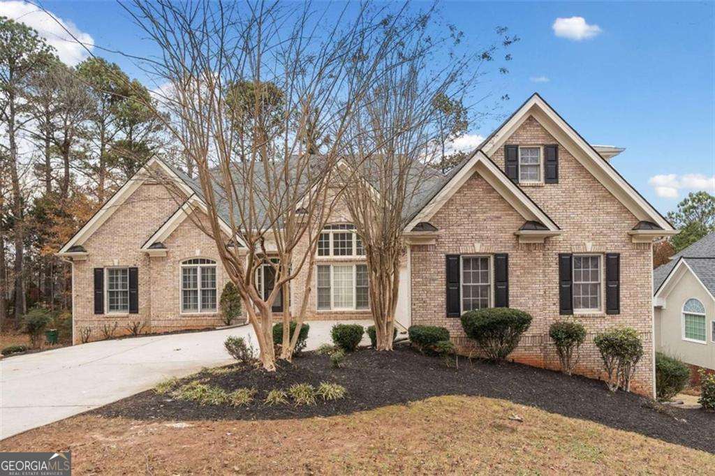 This beautifully renovated ranch-style home with a finished basement offers the ideal balance of comfort, style, and functionality. The classic brick front exterior is complemented by a level driveway and side-entry garage. Inside, you'll find a formal living room, a dramatic two-story dining room with a beaded chandelier, and a gourmet kitchen featuring double ovens, stainless steel appliances, granite countertops, a glass tile backsplash, and a gas cooktop open to a spacious family room with soaring ceilings, a fireplace, and a striking accent wall. The main level is thoughtfully laid out with two distinct wings: one featuring two generous, roommate style bedrooms sharing a full bath, and the other hosting a luxurious owner's suite complete with a sitting area, spa like bathroom with a soaking tub, tiled shower, double vanities, vaulted ceilings, and a walk-in closet. Upstairs, a versatile bonus room or teen suite includes a full bath and walk-in closet. The finished basement is an entertainer's dream with two large living areas, two additional bedrooms, a full bath, and a second kitchen equipped with a sink, electric stove, microwave, and mini fridge. There's also an unfinished space, ideal for a home theater or extra storage. Outdoor living shines with two decks a covered upper deck overlooking a private backyard, and a lower deck perfect for grilling and gatherings. Recent upgrades include Luxury Vinyl Plank flooring throughout, remodeled bathrooms with modern vanities, tubs, tile work, and fixtures, plus updated lighting, recessed lights, chandeliers, ceiling fans, and hardware. Located in the sought after Mirror Lake community near shopping, dining, parks, and major highways, this exceptional home is perfectly suited for everyday living, entertaining, and enjoying life with family and friends.