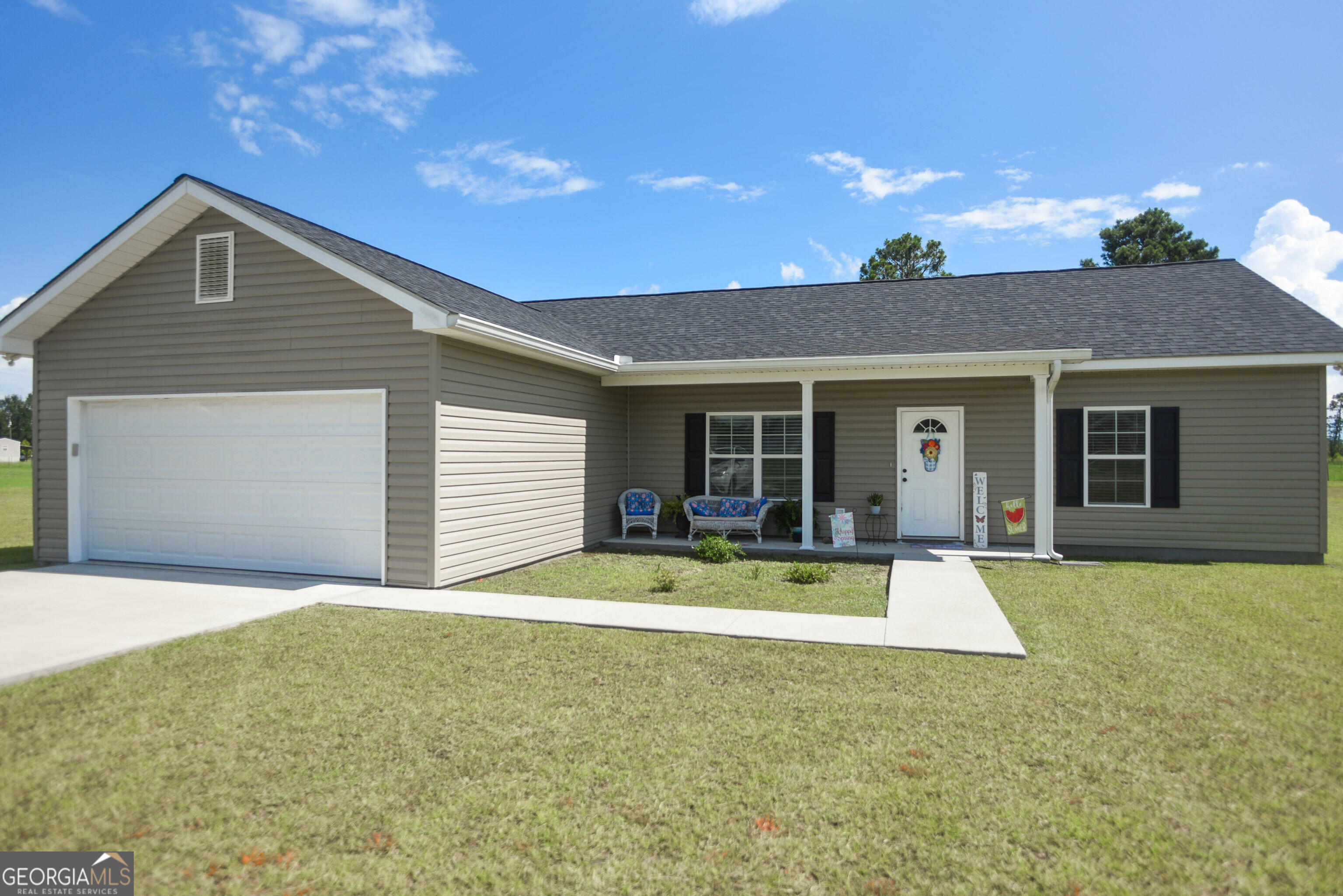 Tucked away on a peaceful 1.05 acre parcel just outside Baxley this charming 3 bedroom, 2 bathroom home captures the essence of southern living. The bedrooms feature ample closet space and the main has an ensuite. Thoughtfully arranged there is an inviting flow from the living area to the dining area and kitchen. One can step outside from the kitchen to the screened porch ideal for entertaining or just taking a nap.A separate building outside is ideal for gardening tools and extra storage.