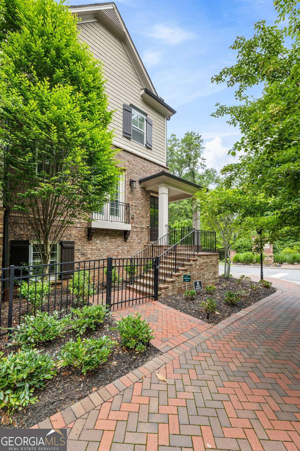 Professionally decorated and beautifully maintained, this immaculate end-unit townhome is located in one of the most desirable pockets of downtown Alpharetta-just steps from Canton Street and Jasmine Garden Way. Offering premier walkability to top-rated restaurants, boutiques, and the vibrant charm of one of Metro Atlanta's most sought-after communities, this home combines luxury, comfort, and convenience. Thoughtfully enhanced with stylish and functional upgrades, the entire interior has been freshly repainted, creating a cohesive, modern backdrop. The primary suite features a tray ceiling and a sophisticated accent wall, while the kitchen island, living room built-ins, and butler's pantry cabinetry have been refinished and paired with updated Kohler hardware and fixtures. A remodeled powder room adds a refined touch, and the drop zone has been updated with fresh paint and hardware for added functionality. Hardwood floors run throughout, complemented by plantation shutters, custom closet systems, and a Phoenix security system with cameras. Additional upgrades include designer lighting and chandeliers, matte black interior and exterior door hardware, and custom Glide-Out shelves by ShelfGenie in the kitchen for optimized storage. The fireplace now serves as a stunning focal point with its new surround and mantle. The garage features an epoxy-coated floor, built-in storage cabinets, a quieter door system with an upgraded opener, and a dedicated 220-volt outlet for EV charging. The open floor plan offers two oversized bedrooms upstairs-each with en-suite baths-and a third bedroom on the lower level, perfect for guests or a private office. A dedicated computer room and a mudroom entry from the two-car garage provide everyday practicality. With extra guest parking, a beautifully landscaped park, and maintenance-free living, this home shows like a model and has been meticulously cared for-with the added bonus of barely being lived in.