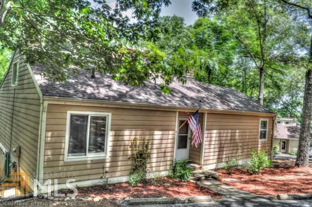 Expanded Cottage offers tons of open space! Recent addition of granite & stainless kitchen with island & breakfast area opens onto a large deck with seasonal views of beautiful private lake! Formal dining room with huge built-in buffet plus soaring vaulted living room allow for great entertaining flow & cheery daily living! Main level master retreat features spa bath & glass doors to sunroom for morning coffee! Hardwood floors; Loft; Unfinished basement; Heated/cooled workshop! Gated resort community with full 24 hr security, manned gates & patrols. Truly a paradise!
