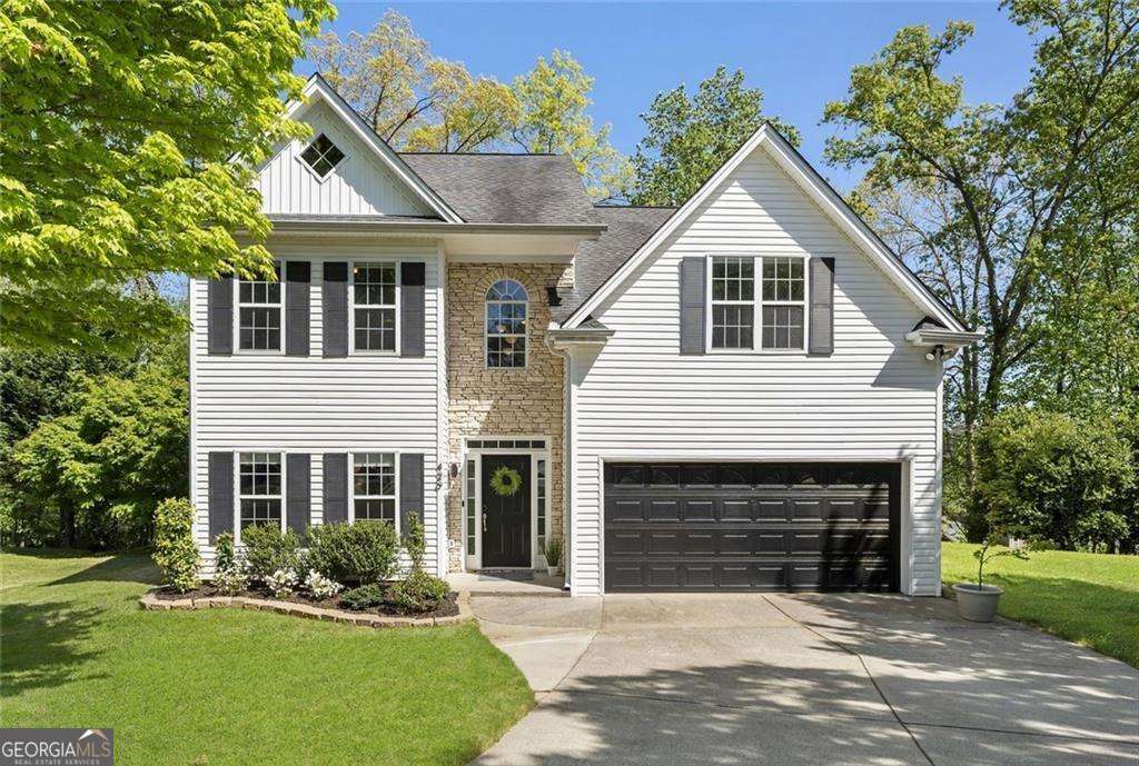 Seller is offering a $5,000 buyer incentive and investor friendly! Nestled at the end of a quiet cul de sac, this beautifully renovated smart home is full of charm and thoughtful modern updates. Inside, you'll find brand-new carpet and flooring throughout, along with remodeled bathrooms featuring all-new cabinetry, fixtures, and stylish designer tile. The kitchen is a true showstopper! Completely updated with Caesarstone countertops, new cabinets and appliances, a feature window, island, and custom wall shelving. It opens to a formal dining room and a cozy living room with fireplace, perfect for entertaining or enjoying quiet evenings at home. Upstairs, the spacious primary suite offers a gorgeous ensuite bathroom, plus three additional bedrooms, another full bath, and a dedicated laundry room. Take in serene forest views from the tub, watch deer from your bedroom window, or unwind on the updated patio surrounded by nature. The entire home is also smart-enabled! From doors to lighting, shades and ceiling fans, and even the appliances, you can control everything effortlessly from your phone, voice assistant, or with wireless control switches placed throughout the home. Additional highlights include a new hot water heater, top-of-the-line washer and dryer, custom his-and-hers closets, and a built-in workspace for the garage. All this, just minutes from the Bowl at Sugar Hill offering concerts, performing arts, splash parks, food, and more!