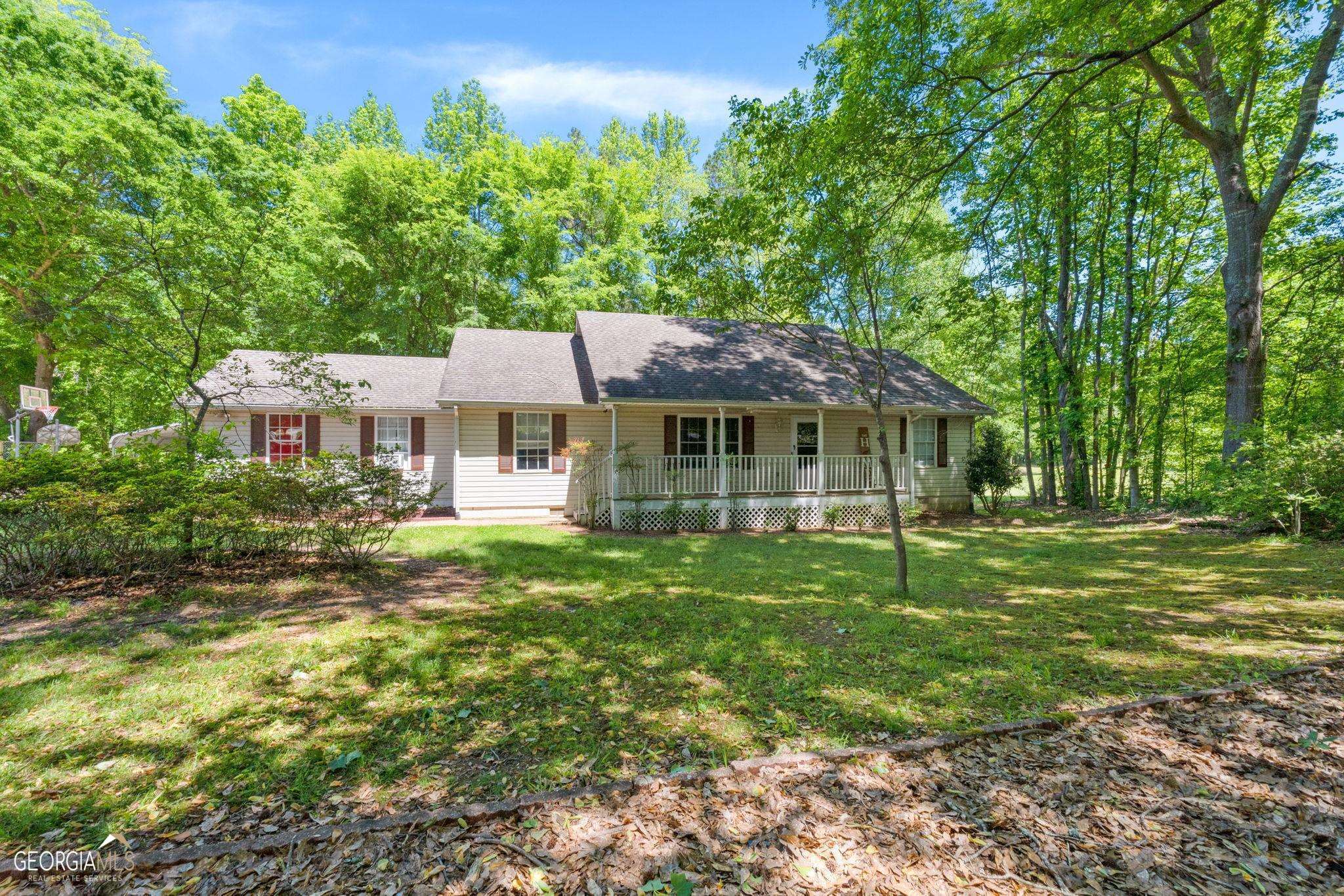 Welcome to this lovely 3 bedroom, 2 bath home with a rocking chair front porch, situated on a spacious 1.26-acre lot. As you approach the home, the inviting front porch sets the tone for relaxation and enjoyment. Step inside and you'll find a spacious living room with vaulted ceilings, creating a grand and open atmosphere. The split bedroom plan offers privacy, with the master suite separated from the secondary bedrooms. One of the standout features of this property is the saltwater pool, providing a refreshing retreat on hot summer days. Additionally, there is a pool house that can serve as a workshop or storage area, complete with a boat door for convenient access. The master bedroom is generously sized, offering ample space for relaxation and personal retreat. The property provides plenty of outdoor space, perfect for gardening, outdoor activities, or even expanding the existing features. Don't miss your chance to own this charming home with its inviting front porch, saltwater pool, and spacious living areas. Schedule your showing today and make this your dream home!