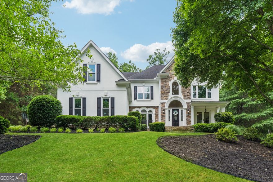 Welcome to 712 Brookshade Parkway where a top-to-bottom renovation meets one of Milton's most sought-after communities, just minutes from the heart of downtown Alpharetta. This stunning 6-bedroom, 5-bathroom home is filled with custom upgrades and thoughtful details throughout. Perched atop a hill with an oak tree-lined driveway and flat backyard, this hardcoat stucco home offers the perfect combination of luxury and privacy. Enjoy a fully renovated chef's kitchen with quartz countertops, a custom vent hood, open shelving, and a spacious scullery with wine fridge. A large window-filled family room and breakfast area overlooks your level, walkout backyard. Outside, the brand new custom outdoor kitchen, stone patio, and fire pit create the perfect space for entertaining. On the main level, you'll also find a guest suite with a fully updated bathroom featuring a walk-in shower and custom vanity, an office space, and large dining room. Upstairs, the expansive primary suite includes a fireplace, sitting room, and a spa-like bathroom with a freestanding tub, oversized shower, and custom white oak double vanity. Plus, the walk-in closet is truly a room of its own. Three secondary bedrooms, one with an ensuite and the others sharing an updated jack-and-jill bath, complete the second level. Don't forget to check out the fully finished terrace level complete with hardwood floors, a custom wet bar, home gym with rubber flooring, and media room. There's even room for further expansion with two unfinished spaces, currently utilized as a workshop and storage with custom built wooden shelving. New windows installed in October 2024 and a brand-new roof to be installed next week are just the cherry on top. Live just minutes from top schools, parks, and the dining, shopping, and charm of downtown Alpharetta with the quiet and privacy characteristic of Milton.