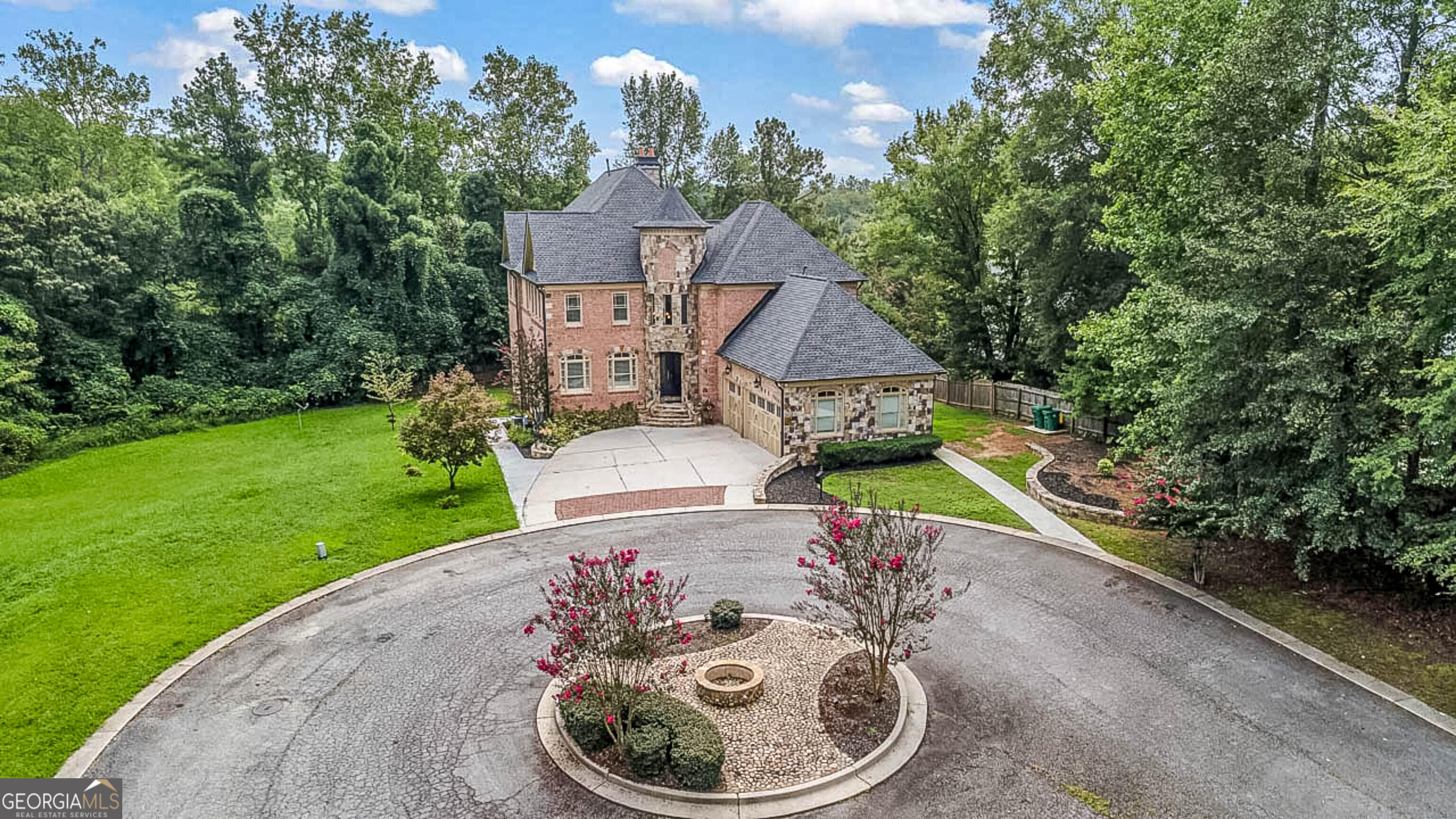 Private Brick & Stone Estate with New Terrace Apartment + Theater Tucked at the end of a quiet cul-de-sac, this 4-sides-brick & stone showplace lives like a private retreat yet keeps you minutes to everything. Inside, light-filled spaces flow from the updated chef's kitchen to fireside living and a deck with outdoor fireplace-your everyday sanctuary. The main-level primary is generous and refined, with an upgraded bedroom and spa bath. Custom hardwoods and millwork elevate the main level, while upstairs offers large secondary suites and flex loft. The fully finished terrace level is the difference-maker: a complete apartment with private exterior entry, sleek full kitchen, gym, oversized media/theater, airy great room, and an additional bedroom and bath-ideal for multigenerational living, long-term guests, or an au pair. Flat, usable yard and wide motor court round out the lifestyle. Highlights: **Full terrace apartment: quartz-top kitchen, island, walk-out to patio, separate entrance **Dedicated gym + true theater with tiered seating & projector **New/refreshes in primary suite & bath; upgraded main kitchen detailing **Custom hardwood flooring and designer lighting throughout main **Theater: tiered recliners, projector, screen-ready for game day & premieres. **Terrace kitchen: quartz island, pantry, open shelving, direct walk-out. **Terrace bath: spa-shower with niches; fresh, modern finishes. **Terrace bedroom & great room: bright windows, LVP floors, French-door walk-out. **Privacy and circular drive at the end of a quiet cul-de-sac. **Main kitchen: double ovens, large island, views to fireside family room. **Primary bath: dual vanities, stone counters, large walk-in shower.