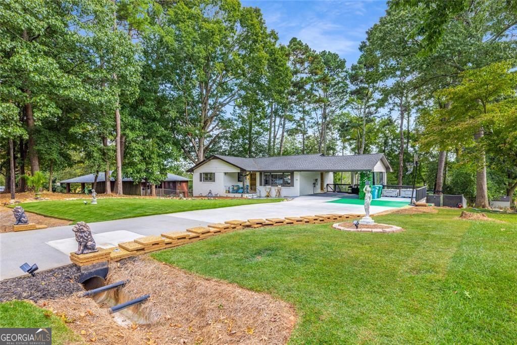 Beautifully updated Norcross home with upgrades inside & out! Features include a new driveway & repaired walkway, refreshed aluminum gates with locks, and a full landscaping overhaul with new sod, rock beds, pine straw, tree trimming, and an accent wall with lighting. Outdoor living shines with a fire pit, shed refresh, and decorative wood fencing. Major improvements include crawlspace encapsulation & roofline critter wrap, EV charger, screen security doors, and ornamental ironwork for style & security. Bonus touches: refinished terracotta porch tile, foam gutter guards, and septic recently pumped. Move-in ready with modern function and unique flair!