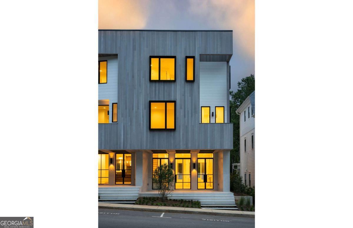 Nestled in the Overlook Hamlet of Serenbe, these modern townhomes epitomize luxury and comfort with their thoughtfully designed open floor plans. The living and dining areas seamlessly blend to create a spacious and inviting atmosphere, ideal for both everyday living and entertaining. Each townhome boasts a charming front porch, perfect for relaxing and enjoying the serene surroundings. The primary suite, located on the second level, offers a private balcony, providing a tranquil retreat with stunning views. Additionally, two versatile flex rooms, located on the second + third floors, feature their own balcony overlooking the treetops, offering a peaceful space for a home office, studio, or additional lounging area. The townhomes also feature en-suite bathrooms for each of the three guest bedrooms, located on the third floor, ensuring privacy and convenience for guests alike. Overlook is Serenbe's newest pocket neighborhood, featuring immediate access to over 20 miles of soft surfaced nature trails with protected forest views + a short distance to every Serenbe wellness amenity.