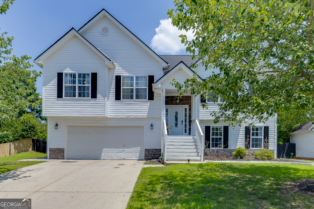 Welcome to this beautifully maintained split-level home located in the desirable Seckinger High School district in Buford. Offering 5 bedrooms and 3 full bathrooms, this spacious residence is perfect for multi-generational living or those in need of extra space. The main level features an inviting eat-in kitchen with a cozy breakfast room, white cabinets, a pantry, and a clear view into the family room highlighted by a warm fireplace. A separate open-concept dining room provides the perfect setting for entertaining. The oversized master bedroom features a tray ceiling and a newly updated floor, along with a private ensuite bathroom that includes a double vanity, separate soaking tub, and walk-in shower. Another bedroom on the main level also features new flooring, and the laundry room is conveniently located nearby. The lower level offers a full in-law suite with its own kitchen, private bathroom, and a separate entrance through the garage ideal for guests or extended family. Enjoy peaceful mornings with stunning sunrises from the back deck overlooking the large, fenced-in backyard, complete with a fire pit and level yard for outdoor activities. A newly installed front-facing fence adds charm and privacy to the property. The two-car garage includes a laundry hook-up, and both private front and rear entrances enhance the home's accessibility and functionality. This home blends comfort, flexibility, and thoughtful updates in a prime Buford location.