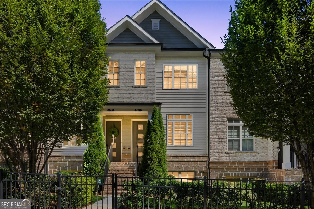 Don't miss out on maintenance-free townhome living! Situated in a gated enclave with the coveted Buckhead location. Spacious 2 beds/2 full baths and 2 half baths! Terrace level flex space could be for guests, office, or playroom/second family room. Kitchen features designer-gray cabinetry, SS appliances, decorative herringbone backsplash, built-in microwave, and quartz countertops. Bedrooms each feature ensuite baths and walk-in closets. Master bath has huge walk-in shower with frameless door. Upgrades include hardwoods in all living spaces, recessed lighting throughout, and upgraded white-stone fireplace and mantle. Wrought iron spindles on all stair railings, large attic storage space, and a one car garage for weather protected parking.This home has tall ceilings throughout, receives a ton of natural light, and has a private back deck perfect for entertaining or enjoying the sunset. Community features security gate and pool. Walkability to Chastain Park, restaurants, stores, and easy access to GA400/I-285/Buckhead. You cannot beat this price for this location and quality!
