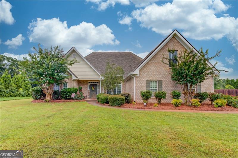 Wow! Super spacious ranch with an upstairs bonus room located on a great, level lot. From the moment you walk in, the high ceilings and open concept floor plan allow for loads of natural light to flow effortlessly through the home. The formal dining area is perfect for entertaining, while the eat-in area in the kitchen is great for everyday, casual dining. Featuring a breakfast bar, stainless appliances, large pantry and plenty of storage, this kitchen is equipped with everything one would need while also providing a great atmosphere overlooking the family room. Boasting a lovely brick fireplace, the family room and hardwood flooring, this is certainly the place to relax in the home. The oversized primary bedroom offers a lovely reading room in addition to the relaxing en suite bathroom featuring a separate shower and soaking tub. Two additional guest bedrooms along with another full bath round out the main floor living area. Up the stairs you will find a bonus area and third bathroom. This can easily become a fourth bedroom, your home office, additional entertainment area, whatever your heart desires. Enjoy the backyard minus those pesky bugs while you sit on your back screened in patio. The yard is ready for all of your gardening delights or put that pool in you have always wanted. The possibilities are endless with this backyard. Near all area amenities, this home is the one you have been looking for.