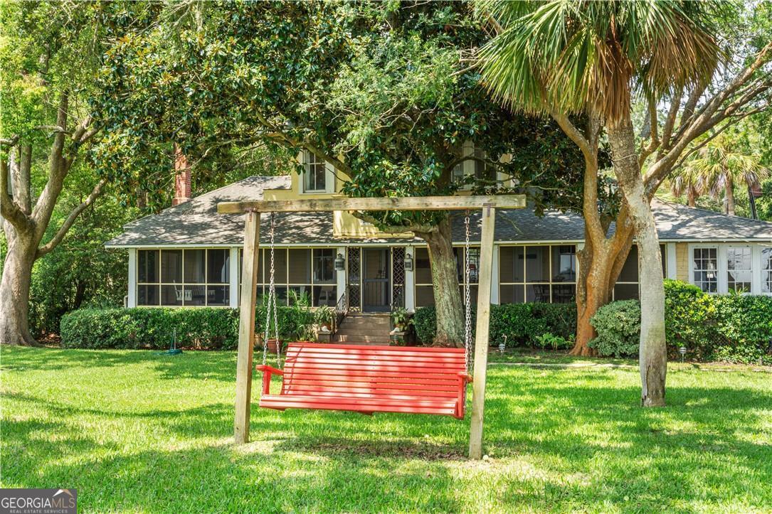 LEGACY BEACHFRONT PROPERTY. Once in a lifetime opportunity. HISTORIC Oceanfront Beach Home overlooking Jekyll Island between the Sea Island Lodge & Golf Club and the Pier/Village/Lighhouse. Tucked away on a moss-draped, oak-canopied side street- quietly set apart yet central to the best of St. Simons Island. Walk to dinner at the Sea Island Lodge or Georgia Sea Grill. Seine and fish right from the house. Watch ships, shrimp boats, sail boats, dolphins, and the most spectacular sunsets from the screen porch. With choice of anywhere on the undeveloped island, original owner chose this spot for unmatched oceans views and breezes. In all of history, ownership has changed families only ONCE IN A HUNDRED YEARS. Property has 90 FEET of OCEAN FRONTAGE on 5 King City lots with historic 111 year original beach house predating the causeway when island access was by the Emmeline and the Hessey ferries. Lawn is perfect for ocean front garden parties & best location for watching 4th fireworks. Home is in original condition. Gorgeous windows. Heart pine floors. Wood paneling. Butler's pantry. Private second floor suite with enchanting views. Quintessential St. Simons Island beach cottage on the island's premier location with dynamic sunrise & sunset ocean views. PRICELESS! For video copy following url into browser - http://bit.ly/Shelander