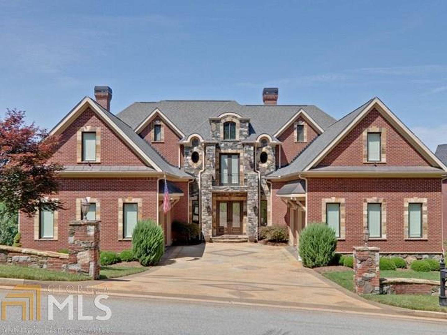 Back on the market PRE-APPROVED short sale that can close in 21 days. 4 finished levels of incredible detail. Wonderfully maintained home in Move in Condition!! Views, views, views! Stunning Lake Lanier views from nearly every room. Fine details through 4 finished levels each accessible by elevator. Luxurious master suite spans entire upper floor w/ multiple fireplaces, walk in cedar closet room, and dramatic sunset lake views. Full bar & home theater. Multiple wet bars in great room & master. Full gym w/ whirlpool tub, shower & sauna. Backup generator. 2 separate 2-car garages w/ courtyard entry. Fire suppression sprinkler system. Boat slip available for purchase in community Marina.