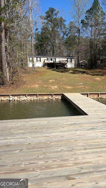 Looking to move to the lake? Prefer a weekend escape? This charming 3 bedroom, 2 bath manufactured home is in great condition and located on beautiful Lake Sinclair. The community boat ramp is on the lot next door which adds to the convenience of the location. The large lakeside deck is the perfect spot for enjoying your morning coffee or unwinding as the sun sets. The owner has recently installed a new seawall and max dock which enhances the beauty of this waterfront property. Schedule a showing today and experience the beauty of life at Lake Sinclair.