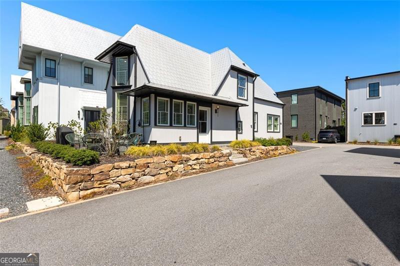 Welcome to this stunning 3 bedroom, 3 full bath home in the heart of Trilith! Designed with flexibility in mind, you'll love the option of a primary suite on the main level or upstairs. The home is positioned perfectly near one of Trilith's outdoor living parks, giving you the ability to enjoy outdoor living without all of the work! The light-filled open living and dining space features soaring ceilings, hardwood floors, and floor-to-ceiling windows with remote-controlled blinds and custom window coverings. The kitchen boasts stainless steel appliances, stone counters, and a pantry - perfect for everyday living and entertaining. Upstairs you'll find a second primary suite with a spa-inspired bath and walk-in closet, plus a versatile loft/flex space for a home office or lounge. Outdoor living is easy with a private patio where you can host family and friends, while two dedicated parking spaces add convenience. As part of Trilith, you'll enjoy world-class amenities: 15 miles of walking trails, resort-style pool, tennis courts, pocket parks, a state-of-the-art wellness center, dog park, and the vibrant Town Centre with dining, shopping, and entertainment just steps away. Perfectly located across from Trilith Studios and minutes to Peachtree City, the airport, and Atlanta - this home offers the best of live, work, and play!