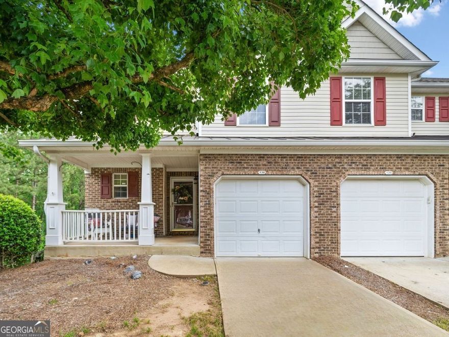 End-Unit Charm in Fox Creek! Welcome to this end-unit townhouse that's move-in ready and well-maintained. It sits in a peaceful cul-de-sac within Woodstock's popular Fox Creek community. From its inviting front porch to its open, light-filled layout, this home is designed for comfort and connection. A wide hallway leads past a convenient powder room to an open-concept  living space, featuring the open-spindle staircase for airy-ness and extra light, where daily life flows easily. The kitchen features a breakfast bar, an eat-in dining area, recessed lighting and a clear view of the living room, making it ideal for entertaining or relaxing at home. Step onto the freshly painted back deck and enjoy peaceful views of the surrounding woods. You'll appreciate the privacy and the large, level backyard, a rare find in a townhome and perfect for play or pets. Upstairs, a spacious loft provides flexible space for a home office or cozy reading nook. The primary suite features an en-suite bath with a soaking tub, separate tile shower, and double vanities. A secondary bedroom, full bath, and conveniently located laundry closet complete the upper level. The finished walk-out basement provides plenty of storage. It's perfect for a home gym, guest suite, or media room. Bathroom plumbing stubs are already in place. Fox Creek offers fantastic amenities, including a pool, tennis courts, playground, lawn care, and trash service. Located just minutes from Downtown Woodstock, walking trails, parks, and top-rated schools, this home has everything you need. Don't miss your chance to make it yours!