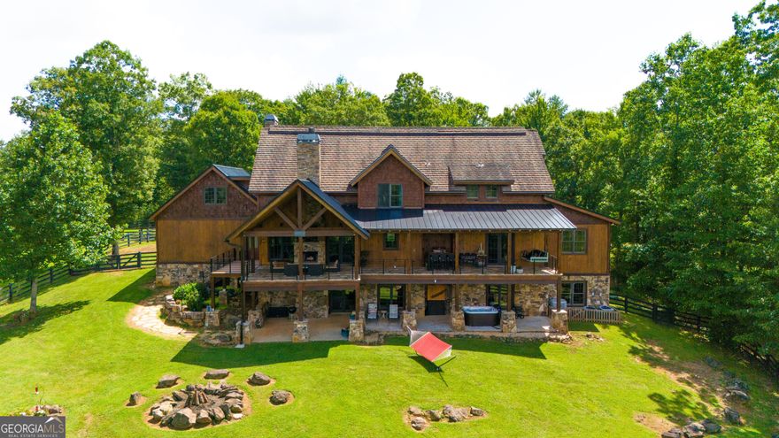 Don't miss this incredible opportunity to own the ultimate mountain retreat at 98 S Saddleback Trail, Blue Ridge, GA! This magnificent 6,975 sq. ft. estate boasts 4 king master suites, each with ensuite baths featuring luxurious tile showers, oversized soaking tubs, custom walk-in closets, and serene sitting areas. Plus, a versatile bunk room or playroom adds to the home's charm.    Enjoy cozy evenings by one of the three wood-burning fireplaces with gas starters or unwind in the brand-new Dimension One hot tub. The house is equipped with modern conveniences, including a whole-house Generac backup generator, two tankless hot water heaters, and a whole-house water filtration system. High-speed fiber optic internet upgraded to 1000 Mbps ensures you're always connected, with a point-to-point system extending Wi-Fi to the barn and the 1,500 sq. ft. storage building/workshop.    The four-level home sits on a sprawling 9.38 acres with two healthy pastures perfect for animals, year-round grass, and cross-fencing. Additional highlights include a two-car garage, gated entry, all-paved roads, and a past successful STR history.    The property offers stunning long-range mountain views, hardwood, and tile flooring throughout, and a partially finished 2,790 sq. ft. basement with plumbing, HVAC, and electrical ready for your finishing touches.  Embrace the mountain lifestyle with everything you need for comfort, luxury, and outdoor enjoyment!     Also available for purchase with 150 Cadence Way, an expansive 403-acre estate featuring another luxurious home, a 19,200 sq. ft. barn, and a 22,400 sq. ft. covered arena. A rare opportunity to own your dream mountain escape! This listing is available for optional purchase alongside property GAMLS# 10206088, creating a combined 413-acre estate. Included is a 4,659-square-foot home built in 2008, featuring 4 bedrooms and 3.5 bathrooms. The property also boasts a 22,400-square-foot fully covered arena with 19 horse stalls, a foaling stall, a farrier stall, 2 wash bays, a veterinarian room, a tool room, a tack room, a full industrial kitchen, a two-bedroom apartment, 6 baths, a viewing room, 2 laundry rooms, a main floor lobby atrium, and two offices. Additional buildings include an 8,750-square-foot storage barn and a 2,600-square-foot utility shed. The possibilities are endless-whether as an investment with development potential, a grand estate for North Georgia living, or a family getaway for weekends and holidays. This is a must-see property!    Video tour: https://www.canva.com/design/DAGOTXihzEw/slD_HKOSqU7g8ew3yt6fxQ/watch?utm_content=DAGOTXihzEw&utm_campaign=designshare&utm_medium=link&utm_source=editor