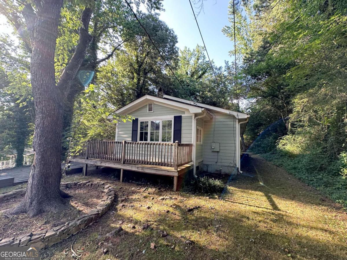 Adorable Cottage Style home with 3 bedrooms and 1160 sf. This makes a great starter home or an ideal investment property as a long-term rental or with the right furnishings a great AIRBNB/VRBO near Main St and everything downtown Woodstock has to offer. New roof in 2022. Kitchen and bath updated with shaker cabinets, granite countertops, and LVP flooring in 2020. Stainless appliances, furnace, vapor barrier, and insulation also in 2020/2021. Original hardwoods and some newer windows. Utility room off kitchen could be used for a small office or additional storage. Property being sold as is with no repairs. Bring your vision, your tender loving care and make this adorable little cottage yours.