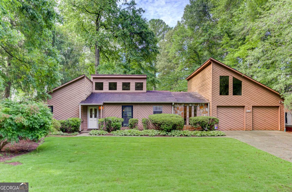 Welcome to this beautifully maintained 3-bedroom, 2-bathroom home offering 2,123 square feet of comfortable living space in a highly desirable, family-friendly neighborhood with top-rated schools. Step inside to find a thoughtfully designed layout featuring an open-concept dining area that overlooks a cozy sunken living room with stunning beamed ceilings and a classic stone fireplace-perfect for entertaining or relaxing evenings at home. The spacious kitchen boasts solid stone countertops, stainless steel appliances, a breakfast bar, and a bright eat-in area. Whether you're preparing meals or gathering with loved ones, this kitchen is both functional and inviting. Enjoy peace of mind with both bathrooms having been fully renovated in the last two years. The primary suite is a true retreat, complete with a large closet and a beautifully updated en-suite bathroom featuring a tiled shower and a brand new soaking tub. The two additional bedrooms are generously sized and share a fully renovated hall bathroom with modern finishes and a tiled-in shower. Outside, the curb appeal shines with a level, landscaped front yard and a serene backyard oasis that includes a flagstone patio, raised flower beds, and lush plantings-ideal for outdoor entertaining or gardening. This home offers the perfect blend of comfort, style, and location. Whether you're a first-time buyer or looking for a long-term residence, this is a wonderful opportunity.