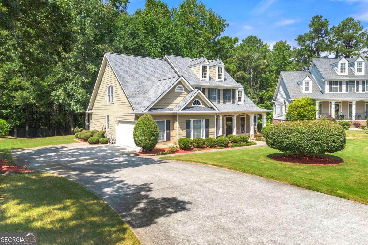 You'll fall in love as soon as you drive into this beautiful neighborhood and up to this Southern Craftsman charmer, perfectly set on a cul-de-sac with a manicured lawn and side-entry garage! Inside, the spacious dining room to your left is ideal for family gatherings and holiday meals. The oversized family room is the heart of the home-perfect for movie nights and game time. The open gourmet kitchen flows seamlessly into the sunroom, where you can start your mornings with coffee and natural light. The first floor offers a luxurious main suite with a large sitting area that's big enough for an office, a sofa, reading nook, or even an exercise space. Relax for hours in the spa-like bathroom with a soaking tub. An additional first-floor bedroom and full bath provide the perfect private space for guests. Upstairs, you'll find generous secondary bedrooms, each spacious enough for kids, guests, or even a home office. Enjoy outdoor living on the covered rocking-chair front porch-deep enough for a swing and plenty of chairs. This home offers space, comfort, and charm in every corner. Don't wait-this one won't last!