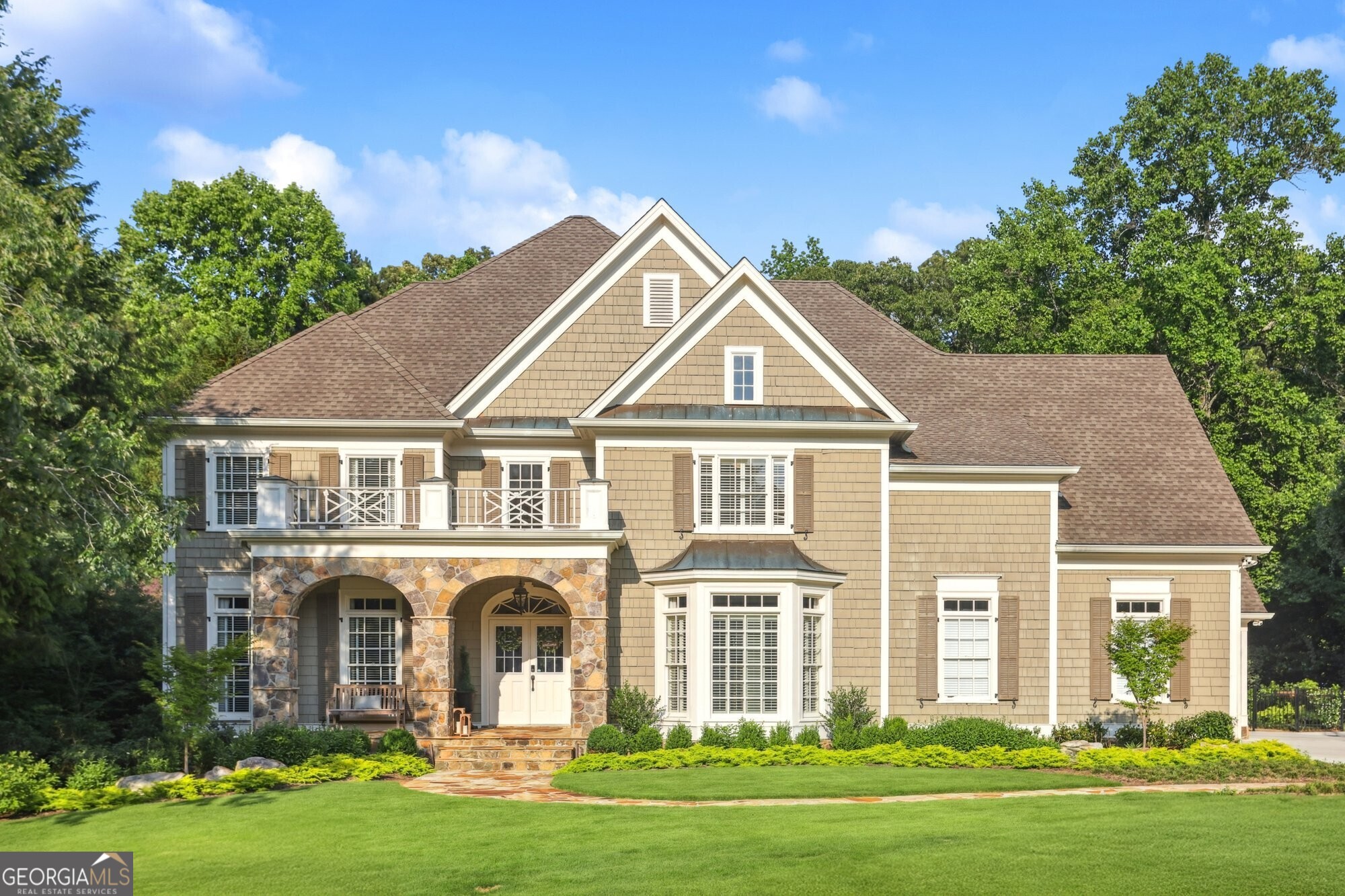 This stunning custom-built Rick Greene residence blends timeless elegance with the latest in smart home technology and luxurious upgrades. Located just steps from the neighborhood swim and tennis amenities, this beautifully designed home offers a renovated main-level primary suite featuring heated marble floors, a steam shower, a freestanding soaking tub, quartzite countertops, and fully customized closets-your private spa retreat. The gourmet chef's kitchen is a dream come true, outfitted with top-of-the-line Wolf and Thermador appliances, a Sub-Zero refrigerator, an oversized island, and matching quartzite counters and backsplash. Upstairs, you'll find three spacious en suite bedrooms with recently updated bathrooms that maintain the home's elevated style. As seen on HGTV, the fully finished terrace level is perfect for entertaining, complete with a custom bar (with ice maker, dishwasher, and beverage fridge), media room, billiards room, guest suite, home gym, and a walk-in 200-bottle refrigerated wine cellar. Step outside to enjoy the professionally designed stone patio with a gas fire pit and the covered porch with a fireplace-ideal for year-round enjoyment. With every modern convenience and curated design detail, this home is move-in ready and truly one-of-a-kind. Don't miss your chance to own this masterpiece of comfort, technology, and style.