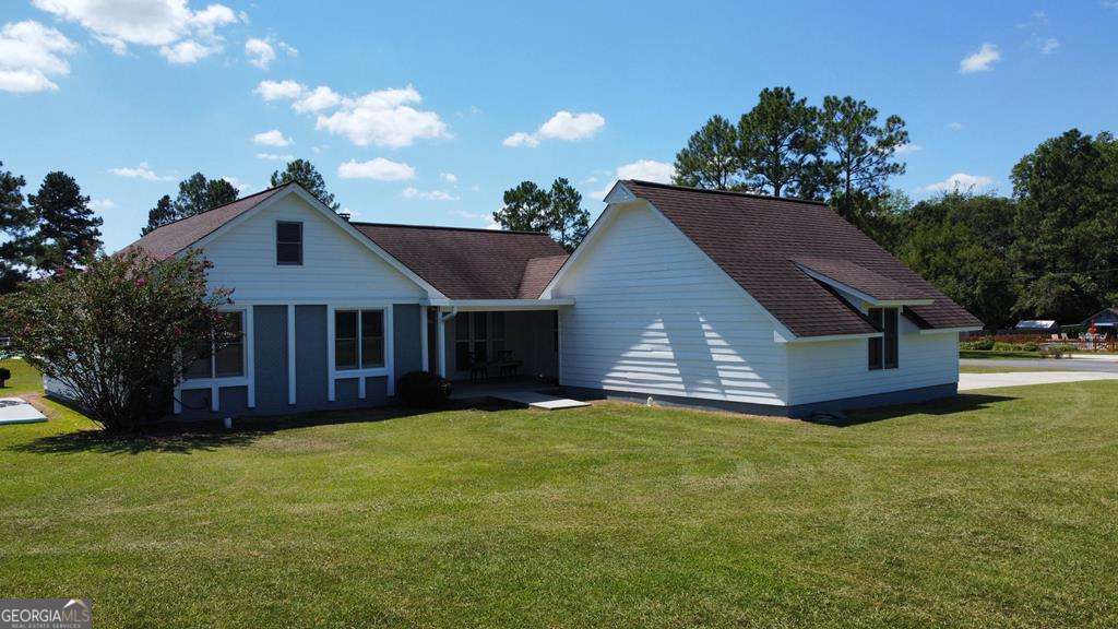 This 4bedroom 3bath home is located on a corner lot on .73 acres. This home features a family room with a stone fireplace open to the kitchen. Kitchen with tiled floors, stained cabinets, stove/oven, dishwasher & vent hood. Large laundry room off the kitchen with cabinets & pantry area. Enclosed garage has been made into a master bedroom with laminate floors & walk-in closet. Master bath with tiled shower, tiled floors, & separate tub. Split floor plan features 3bedrooms & 2 baths on other end of home. One bedroom with private bath that includes tub/shower combination, tiled floors & single vanity. Two guest bedrooms share hall bath with tub/shower combination. Newer exterior doors & storm doors to back deck. Back deck with seating for guest. 12x22 storage building on a slab. Large corner lot.