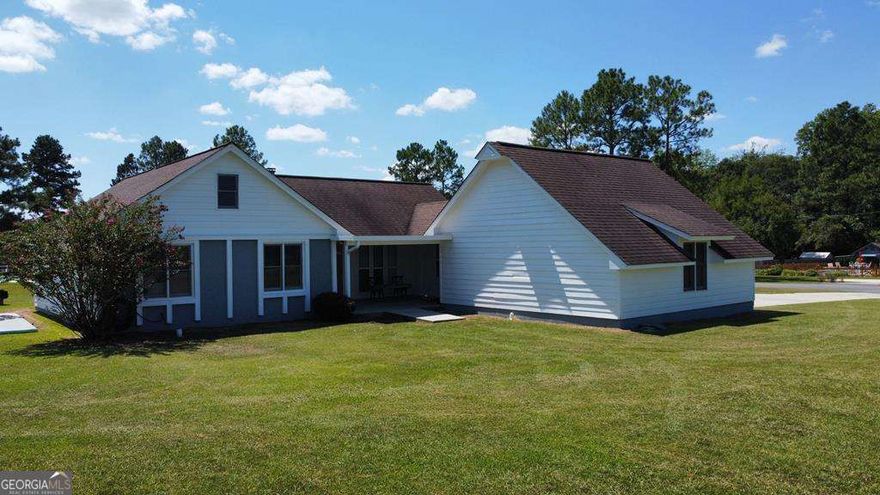 This 4bedroom 3bath home is located on a corner lot on .73 acres.  This home features a family room with a stone fireplace open to the kitchen.  Kitchen with tiled floors, stained cabinets, stove/oven, dishwasher & vent hood.  Large laundry room off the kitchen with cabinets & pantry area.  Enclosed garage has been made into a master bedroom with laminate floors & walk-in closet.  Master bath with tiled shower, tiled floors, & separate tub.  Split floor plan features 3bedrooms & 2 baths on other end of home.  One bedroom with private bath that includes tub/shower combination, tiled floors & single vanity.  Two guest bedrooms share hall bath with tub/shower combination.  Newer exterior doors & storm doors to back deck.  Back deck with seating for guest.  12x22 storage building on a slab. Large corner lot.