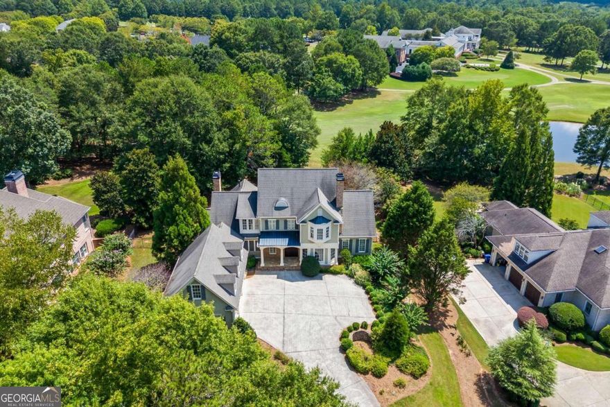 OPEN HOUSE SUNDAY 2-4 *** NEW ROOF. NEW INTERIOR PAINT. NEW HARDWOOD FLOORS THROUGH OUT!***  Experience luxury and comfort in this extraordinary 5-bedroom, 5 full-bath, and 1 half-bath home, perfectly situated on hole #9 of The Georgia Club's exclusive golf course within the Fairway Heights Community. With over 6,000 sq. ft. of stunning living space, this residence blends elegance, functionality, and breathtaking views. Spacious interior with heart pine flooring, high ceilings, granite, tile, and large windows. Two gas fireplaces - in the family room and screened porch. Gourmet chef's kitchen with high-end GE Profile appliances, double ovens, pot filler, island seating, and built-in corner bench. Hidden bonus room with 7.2 surround sound system, mini split AC, natural light from four windows, and dormer nooks perfect for reading. Formal dining room with built-in lighted oak display shelves and glass doors. Central ceiling speakers for background music on the main level, with conduits from the basement to the 2nd floor for future expansion. Main-level owner's retreat with a spa-like bath, soaking tub, multi-head walk-in shower, dual vanities, and custom split closets. Private office, nursery, or lounge connected to the primary suite. Upstairs are 3 additional bedrooms with 2 full baths, and bonus flex spaces. Flex space ideal for a computer/office workspace or a future cedar closet. Mini master guest suite featuring a bay window with a built-in seat and stunning sunset views. Appreciate the wood-paneled stairway & hallway leading to the basement where you are sure to enjoy the home theater with 5.1 surround system, Bose speakers, rear AV access and an independent mini-split. Enjoy the private gym with mirrored walls and a unique window design looking into the hallway. A saloon-style entrance into a game room with pool table, bar seating, mini fridge, sink, microwave, icemaker, and dishwasher and 7.1 surround system.  An additional guest suite beyond the game room, through a glass door with closer, featuring a large bath and natural light from ground-level windows. This home has spectacular Club House view from the rear deck/porch and golf course views and direct access to rolling fairways. Enjoy the community garden, walking trails, and golf cart paths. No shortage of parking with the three-car garage with Tesla 220V charging outlet with additional parking for three at the top landing, excluding the driveway. Whole-house RainSoft water softener system & central vacuum system. Recently repainted, including all base trim. Don't miss this rare opportunity to own a golf course masterpiece in The Georgia Club's gated community.