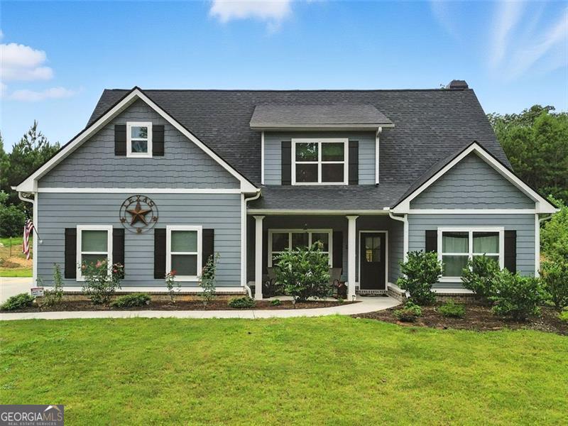 This beautifully updated craftsman-style home offers the perfect blend of comfort, function, and privacy-nestled on 6.47 serene acres just minutes from Downtown Tallapoosa and with no HOA. The main level features a desirable primary suite with custom-tiled bathroom, along with a second bedroom and full bath, ideal for guests or a home office. Upstairs, you'll find two additional bedrooms, a full bath, and a spacious finished bonus room-perfect for a media room, playroom, or extra guest space. The open-concept floor plan centers around a large kitchen island overlooking the vaulted family room, ideal for entertaining. Granite/quartz countertops, stainless steel appliances, hardwood floors, and detailed finishes throughout provide both beauty and durability. Since purchasing the home, the owners have invested over $65,000 in upgrades, including: private pool with surrounding sidewalk and electrical outlets, white vinyl privacy fencing around the pool area, approximately 4 acres fully fenced with two gated entrances, two new storage sheds and expanded concrete pad for additional parking. With acreage, upgrades, and charm, this property offers the freedom of country living without sacrificing modern comfort. Schedule your tour today to experience all it has to offer!