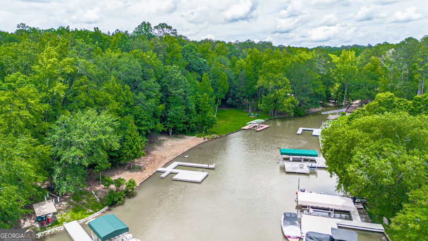 Lakefront .85-Acre Lot in Double Branches on Lake Oconee!  Incredible opportunity to own a premier lakefront lot with deep water and new upgrades in the sought-after Double Branches subdivision. This gently sloping .85-acre lot features a NEW max dock, wood seawall, and a recently dredged cove, offering deep water beyond the dock-ideal for swimming, boating, and year-round enjoyment.  Build your custom lake home on this private, peaceful lot nestled in a quiet cove with long water views. Located just minutes from restaurants, shopping, and golf, this property offers the best of Lake Oconee living.      Features Include:  .85-acre lakefront lot  NEW max dock for boats & watercraft  Wood seawall installed  Deep water access due to recent cove dredging  Peaceful, private cove setting  Gently sloping lot ideal for terrace level walkout  Established Double Branches community  Close to Greensboro, Eatonton, & local amenities    Don't miss this rare chance to own a ready-to-build lakefront lot with major improvements already complete. Bring your plans and builder-Lake Oconee living starts here!