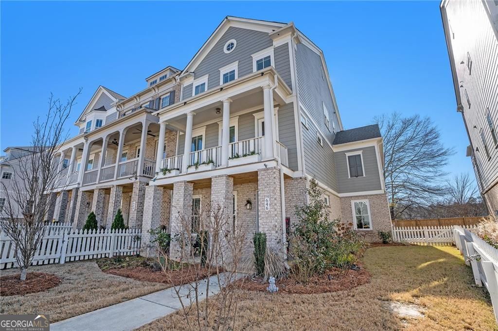 Enhance your lifestyle in this beautiful three-story end-unit townhouse featuring an ELEVATOR by John Wieland at South on Main! A perfect blend of modern design, luxury finishes, and unbeatable amenities awaits. Step inside this luxurious plan designed for contemporary living. The expansive three-car garage opens into a mudroom with bench seating, cubbies, and hooks for effortless organization. A keeping room with extra windows bathes the space in natural light. At the same time, the gourmet kitchen boasts 10-foot ceilings, tall cabinetry, quartz countertops, stainless steel appliances (including a microwave drawer) and a walk-in pantry. The kitchen flows seamlessly into the great room, featuring a gas log fireplace and built-in bookcases. Retreat to the primary suite with its private relaxation nook and an ensuite bath complete with a soaking tub, frameless glass shower, and tile to the ceiling. Upstairs, retreat to the primary suite with its private relaxation nook and an ensuite bath complete with a soaking tub, frameless glass shower, and tile to the ceiling. You will also find a secondary bath, and a laundry room with an extra-deep sink. Outdoor living shines with two front porches and a screened rear deck with Trex decking perfect for grilling. Upgrades include outdoor landscape lighting, landscaping, and plantation shutters. Located less than half a mile from downtown Woodstock, South on Main offers premium amenities, including a 6,000 sq. ft. clubhouse, fitness center, pool, dog parks, community garden, and more. Direct access to the Noonday Creek Trail makes this a dream home for active lifestyles!