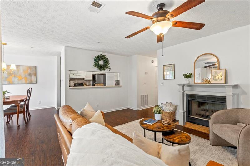 Welcome home to this upper-level 2-bedroom, 2-bath condo that checks all the right boxes. From the assigned parking space right out front to the cozy gas log fireplace, it provides easy, everyday living. Durable wood-look plank flooring throughout stands up to kids, pets, and busy routines-so you can enjoy your space without worrying about upkeep. Bonus: there's a private storage closet right on the patio. Enjoy quick access to MARTA, Hwy 78, I-285, shopping, and Stone Mountain Park, all while tucked inside a quiet, well-maintained community. Roof replaced by the HOA last year! Washer, dryer, and refrigerator are included, making move-in budget-friendly. Community amenities include a playground, pool, tennis/pickleball courts, and clubhouse. This condo community is already approved for conventional financing with standard 30-year fixed rates, thanks to Kimberly Nehiley Akins at Supreme Lending. Call today-because the right home at the right price doesn't wait around.