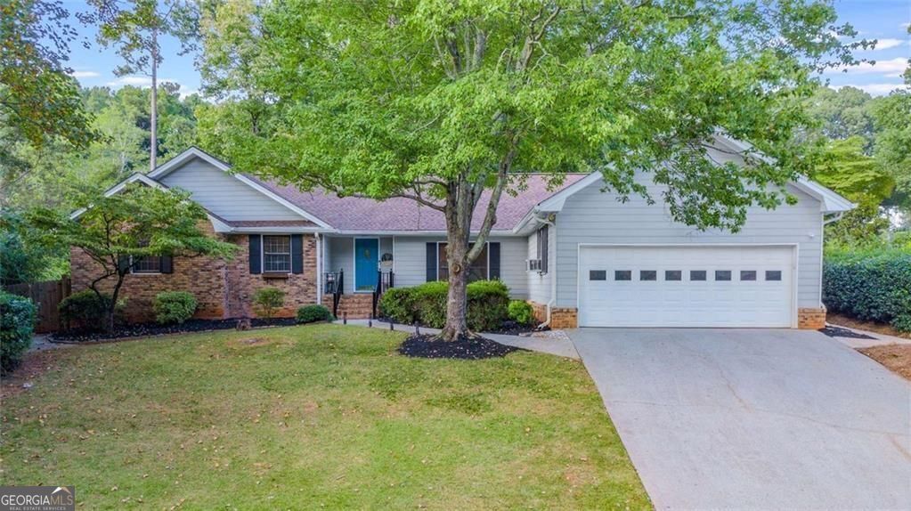 Welcome to your Dream Retreat! Stunning 4 bed / 2.5 bath Ranch in sought-after Pine Cove subdivision in the Livsey District. Over 2,100 sf of living space featuring a vaulted Great Room with beams, brick fireplace, built-ins, and LVP flooring throughout. Renovated Chef's Kitchen boasts new stone counters, two-tone cabinetry, stainless steel appliances, oversized sink, and Breakfast Nook. The oversized Primary Suite includes a sitting area, spa-like bath with frameless double shower, new double vanity, and custom walk-in closet. Sunroom with independent mini split AC offers flex space for office or wellness room. Secondary Bedrooms include a Jack-n-Jill bath plus a sunny bay-window room ideal for an extra bedroom, office, or guest space. Dedicated Laundry Room with washer/dryer included. Outdoor Living area perfect for entertaining with hot tub, firepit, newly paved patio, and wooden fence. Major updates: new HVAC (2024), roof (2021), EV-ready garage, and smart exterior lighting. Prime location near downtown Tucker dining, shops, and parks with easy I-285/I-85 access. No HOA. Schedule your showing today!