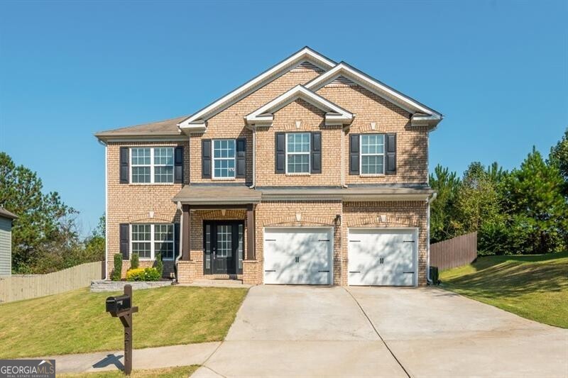 This drop-dead, gorgeous home will delight with its well-integrated open concept floor plan, high ceilings and stylish transitional finish. Upon entering the sweeping two-story, light-filled foyer, you'll immediately notice detailing typically seen at a much higher price point in the dining room just off the foyer which showcases a feature wall and a rustic beam to provide warmth and character. Progressing into the home and passing the generous hall closet with barn door, your eyes will be drawn to the upscale marble-like porcelain fireplace wall with stylish floating shelving perfect for showcasing your prized possessions. The living room and kitchen with dining nook will accommodate even a large gathering for family and friends-with the ability to spill out onto the back patio through the exterior door near the nook. The kitchen's focal point is the exotic stone waterfall edge island, matching surrounding counters and the premium marble backsplash, creating a transitional, classic finish that will work with many decors. The powder room, laundry and garage are accessed through a hall off the kitchen. When the day is done head up to the owner's retreat with its oversized bedroom with a tray ceiling, seating area, spa-like primary bath and spacious walk-in closet. The secondary bath serves the 3 other upstairs bedrooms. You'll be sure to enjoy your own fully-fenced flat backyard with plenty of room for playing, pets, or just experiencing the out of doors in your own private sanctuary. This cute and quiet community features wonderful amenities such as a playground, swim/tennis and a clubhouse, a perfect launching pad for all that Canton and North Georgia have to offer. Agent is related to seller.
