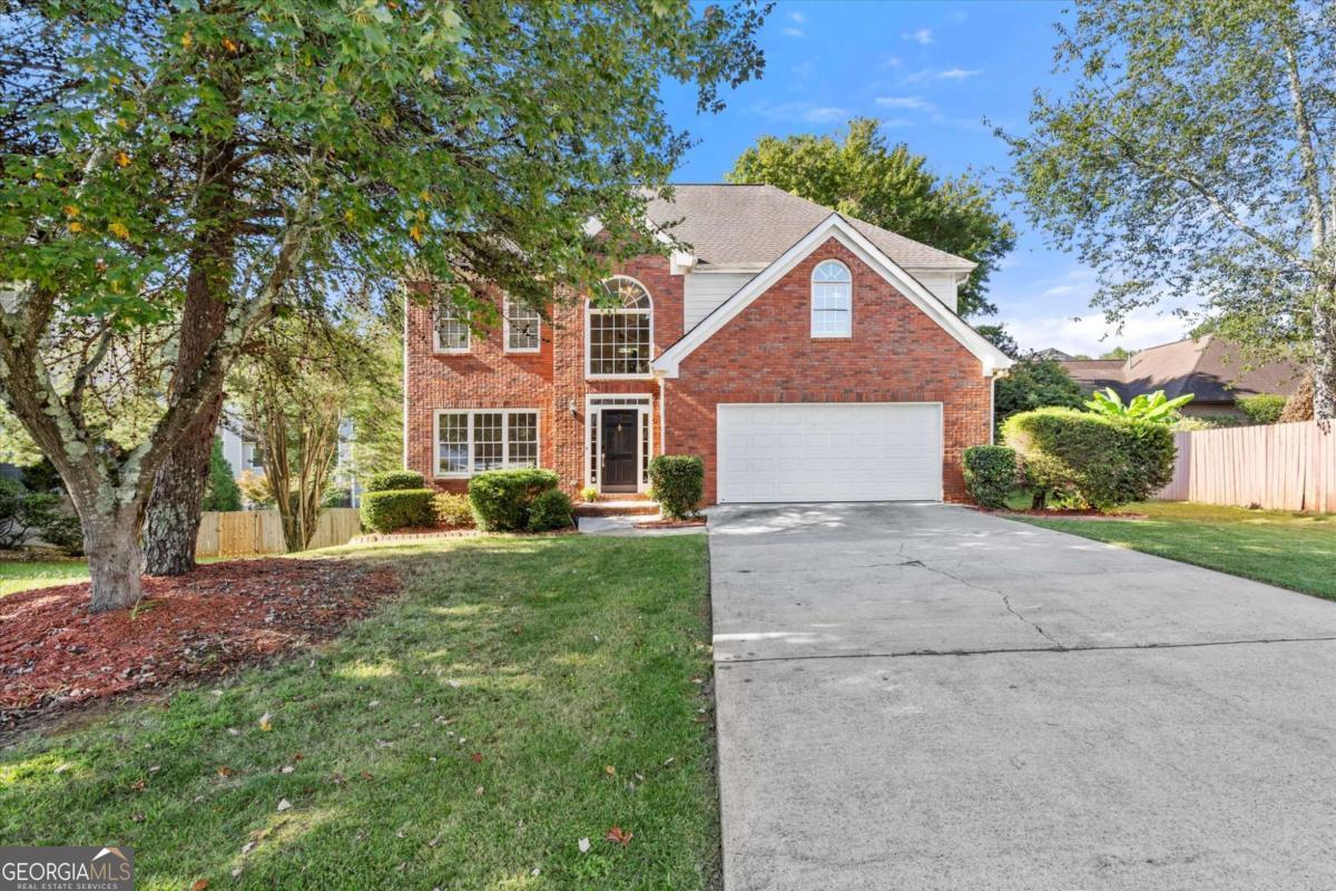 Welcome to this stunning 5-bedroom, 3.5-bathroom home nestled in The Gates subdivision of John's Creek. Beautiful hardwood floors flow throughout the main living areas, creating warmth and elegance from the moment you step inside. The main level features a formal living room which can also serve as a flex space or office space, as well as a separate dining room ideal for hosting formal meals. The updated bathrooms showcase modern finishes and stylish design. Upstairs, you'll find four spacious bedrooms and two full bathrooms, offering plenty of room for family and guests. The full daylight walkout basement adds exceptional living space, including an additional bedroom and bathroom-perfect for a guest suite, media room, or recreation area. Step outside to enjoy a spacious, flat fenced backyard designed for play, pets, or entertaining, along with an outdoor deck that's perfect for grilling or relaxing. Residents of The Gates enjoy wonderful community amenities, including a pool and playground. Conveniently located near top-rated schools, shopping, dining, and all that John's Creek has to offer, this home is a must-see!