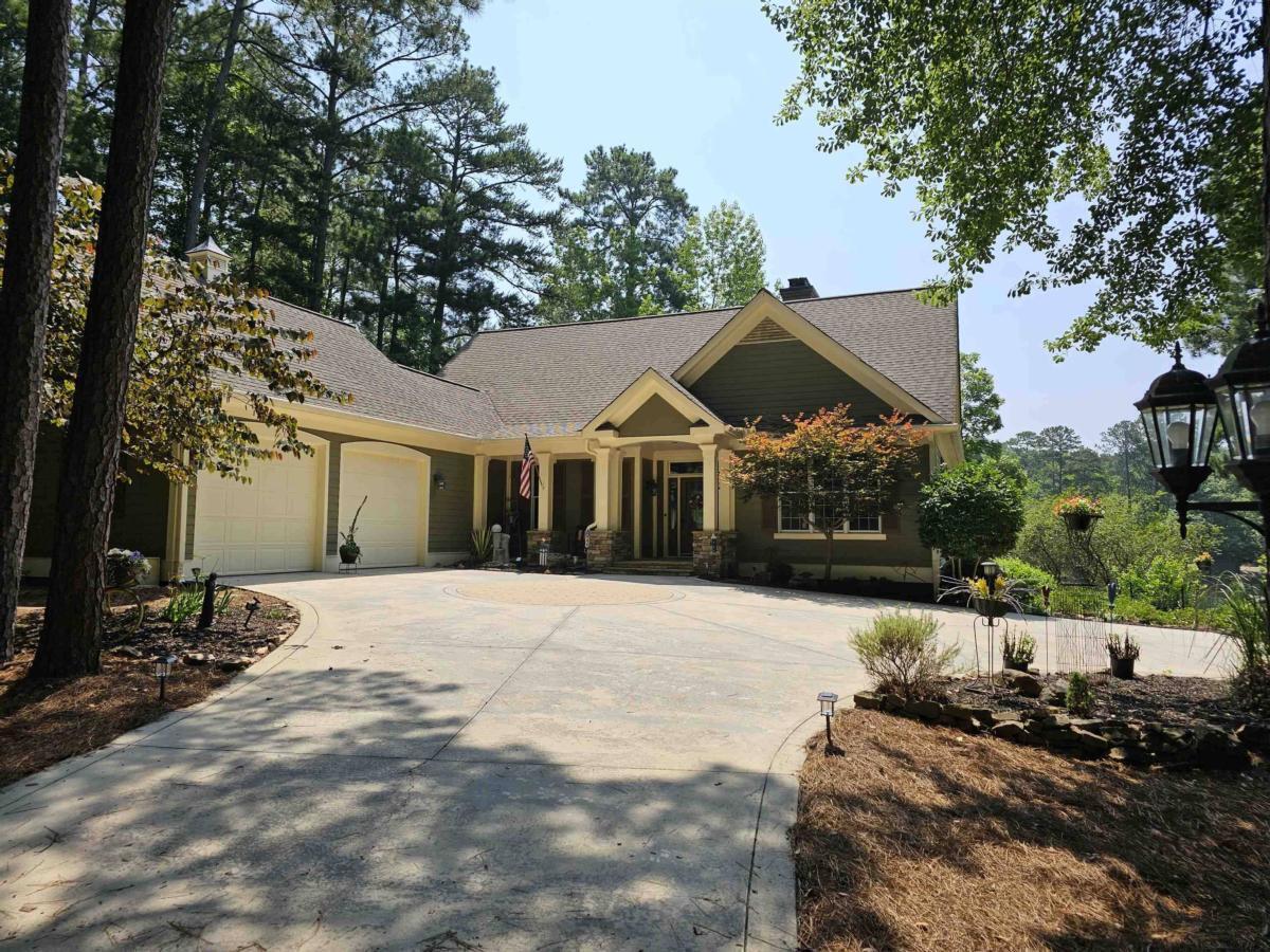 This rare gem within Reynolds Lake Oconee is an entertainers dream! Very private setting to enjoy the great views, fish in the pond or take a dip in the pool shared by only twelve property owners but seldom used! NEW ROOF August 2025. This beautiful home has been remodeled to include a floor to ceiling stone fireplace with built in bookcases and custom glass panels leading to a finished lower level. Primary en suite bedroom on the main level with updated bath including a soaking tub, separate shower, heated floors and walk in closet. Convenient office and formal dining room on the main level along with covered lanai for al fresco dining. Open kitchen offers breakfast area and large grilling deck outside. Large second pantry roughed in for future elevator. Beyond the kitchen leads to half bath and laundry room with sink and shower. Two car garage offers fishing room and bait frig! Walk up stairs lead to huge storage area above. The lower level leads to a pool room with wet bar and a walk out entertainment room. Multiple sleeping options include an en suite bedroom, third bedroom, full bath and a sleeping quarters room with four built in bunk beds! Sewing room leads to wine room and second laundry area. Lower third garage with work benches and craft room. Beautifully landscaped low maintenance grounds with patio and fire pit plus walking stone paths throughout! LCA maintains most grass areas. Great rent roll potential for investors! Seller is making a golf membership available.