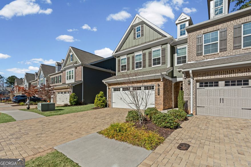Upscale Living Meets Everyday Comfort in This Distinctive Alpharetta Townhome  Welcome to Artisan, one of Alpharetta's most desirable communities, where modern design, comfort, and convenience come together beautifully. This rare end-unit townhome offers exceptional privacy, abundant natural light, and effortless access to Avalon, Downtown Alpharetta, and the Ameris Bank Amphitheatre.  Step inside and experience a bright, open floor plan designed for both entertaining and relaxation. The chef-inspired kitchen is the heart of the home, showcasing a large granite island, stainless steel appliances, plentiful cabinetry, and a walk-in pantry. Whether you're enjoying your morning coffee at the breakfast bar or hosting friends in the elegant dining area, this space is made for connection and style.  The spacious living room is filled with sunshine from oversized windows, while a cozy fireplace sets the perfect mood for relaxing evenings.  Upstairs, unwind in the luxurious primary suite featuring a tray ceiling, big walk-in closet, and a spa-style bath with dual vanities, soaking tub, and glass-enclosed shower. Two additional bedrooms and a full bath offer flexibility for guests, family, or a home office.  A true standout feature, the upstairs bonus area provides extra living space you won't find in other units, ideal for a media room, reading nook, or playroom. Convenience continues with an upstairs laundry room, smart home features, and energy-efficient systems throughout.  Residents enjoy access to a sparkling community pool and playground, plus easy proximity to top-rated North Fulton schools, GA-400, the Alpha Loop, and scenic Greenway trails.  Move-in ready and thoughtfully upgraded, this exceptional end-unit townhome delivers the perfect blend of modern sophistication, comfort, and privacy in an unbeatable Alpharetta location.    Schedule your tour today and fall in love with your next home.