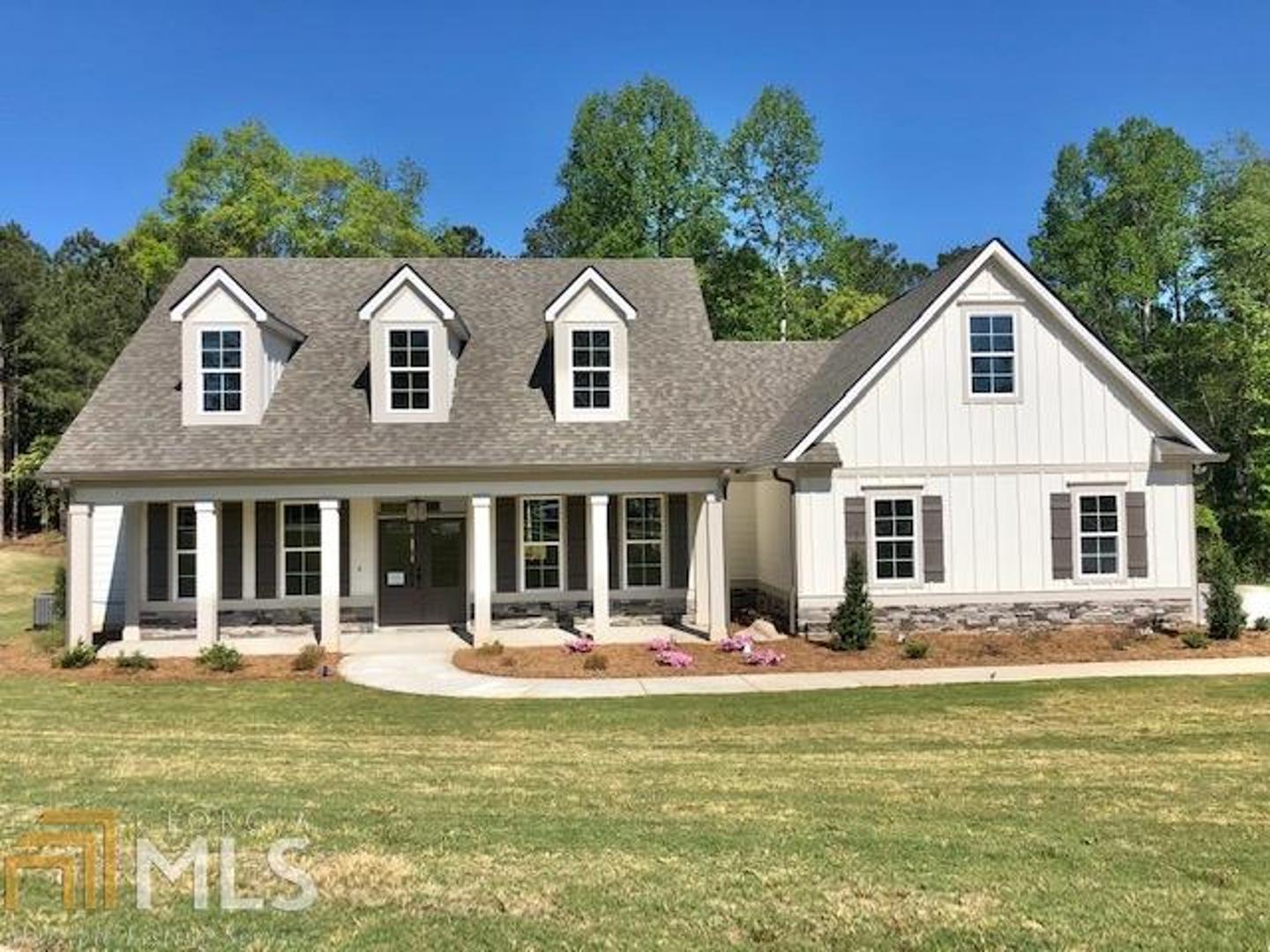 AMAZING SCHOOLS: BROOKS, MADRAS & NORTHGATE**(TRULIA & ZILLOW HAVE INCORRECT SCHOOLS & LOCATION FOR THIS CONVENIENT & UNIQUE NEIGHBORHOOD)**Beautiful Mitch Ginn plan w/ tons of curb appeal*Rocking chair front porch*Rear covered porch overlooks flat backyard*Master & 2 add'l bedrooms on main*Master suite has dbl vanities, gorgeous tiled shower w/frameless glass door, freestanding tub & large closet*Rear stairs lead to lg bonus over 3 car garage, full bath & 4th bedrm*Mudbench, Laundry room to die for*Convenient powder room*Open Kitchen w/ large island overlooking greatrm* Walk-in pantry offers lots of storage*Custom cabinets & upgrades throughout*Designer finishes*Tankless water heater*Walk-in attic storage*Close to new, beautiful amenity area and convenient to I-85 & the Atlanta Airport. NorthShore is a new lake community with a 300+ acre lake, pool w/ zero entry splash pad, tennis/pickle ball, playground, grand lawn! Fabulous schools: Brooks Elementary, Madras Middle & Northgate High!! ***Please be aware that some websites, such as Zillow, Trulia & Realtor.com, have incorrect information regarding NorthShore schools & location despite repeated attempts to have it corrected.