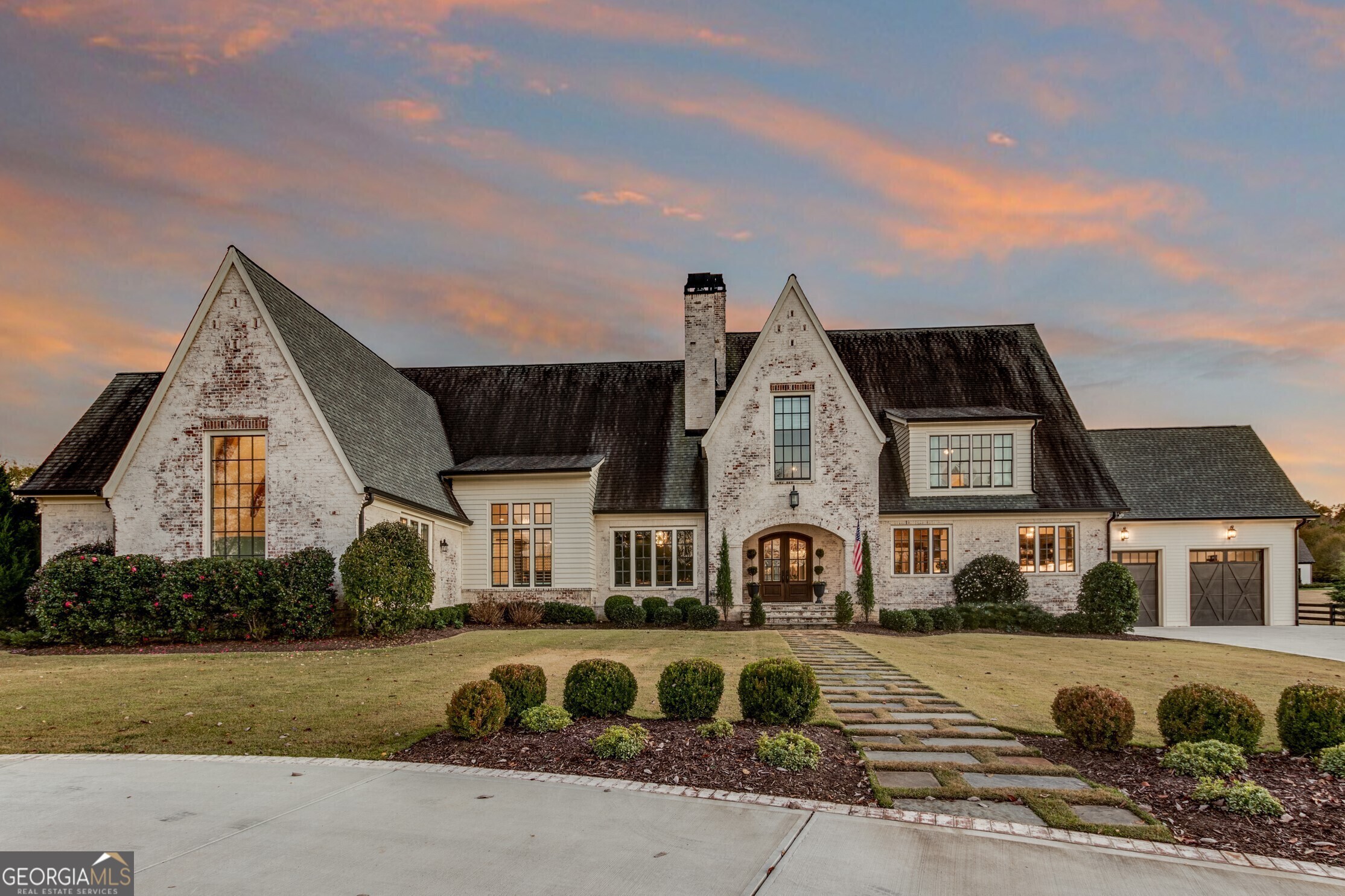 Breathtaking French Farmhouse! Nestled on over 15 picturesque acres, this one-of-a-kind retreat offers peaceful living just 25 Minutes outside of Atlanta. A Custom Arched Double Door welcomes you into this grand home. A Library turned Speakeasy showcases Floor-to-Ceiling Bookshelves, Bar Area, and Cast Stone Fireplace. Hardwood Floors flow from the Fireside Dining Room into a Large Chef's Kitchen with a La Cornue Dual Fuel Range, Built-In Refrigerator and Freezer, Dual Dishwashers, and Oversized Scullery offering ample storage and a Second Oven. Gather and entertain with ease in the Light-Filled Family Room with Custom Herringbone Tile Floors and Built-In Shelving. A stunning Walkway with Floor-to-Ceiling Windows leads into the Expansive Owner's Wing. Unwind in the oversized Owner's Suite with Vaulted, Wood Beam Ceilings, a Spa-Style Ensuite with Dual Marble Vanities, Soaking Tub, and Separate Shower featuring Dual Showerheads, Dual Oversized Walk-In Closets, Separate Laundry Room, and Kitchenette with Full-Sized Refrigerator and Dishwasher. A Full Bedroom with Private Ensuite, Mudroom, Bonus Room, and Half Bathroom round out the Main Level. Upstairs, a Secondary Owner's Suite offers Dual Walk-In Closets and a Private Ensuite with Dual Vanities, Soaking Tub, and Separate Shower. Four Additional Bedrooms each enjoy their own Private Ensuite Bathrooms along with an Upper Level Laundry Room. An additional Loft Space with a Bedroom, Full Bathroom, Kitchenette, and Large Bonus Room presents the perfect space for a Full Home Office or Guest Suite. Downstairs, a Fully Finished Basement delivers the Ultimate Flex Space with a Fitness Room, Recreation Room, and Full Bathroom. Outdoor living is easy with a Heated Pebbletec Pool, Cabana with Climatized Bathroom, Grilling Station, Outdoor Kitchen, and Outdoor Shower. Additional features include a Screened-In Porch with Outdoor Grilling Area, Pergola Covered Seating Area, Barn, Chicken Coop, Playground, Children's Tree House, Raised Garden Beds, Two 24 KW Generators that can power the entire home, and a Commercial Grade Water Purification System . Enjoy gorgeous grounds with over 15 Acres of Scenic Farmland running along Pumpkinvine Creek - the perfect spot for Fishing or Kayaking. A Two-Car Garage and Roundabout Driveway welcome you home. Located just minutes from a Private Airport, LakePoint Sports Complex, Lake Allatoona, Governor's Towne Club, and more with easy Highway Access!