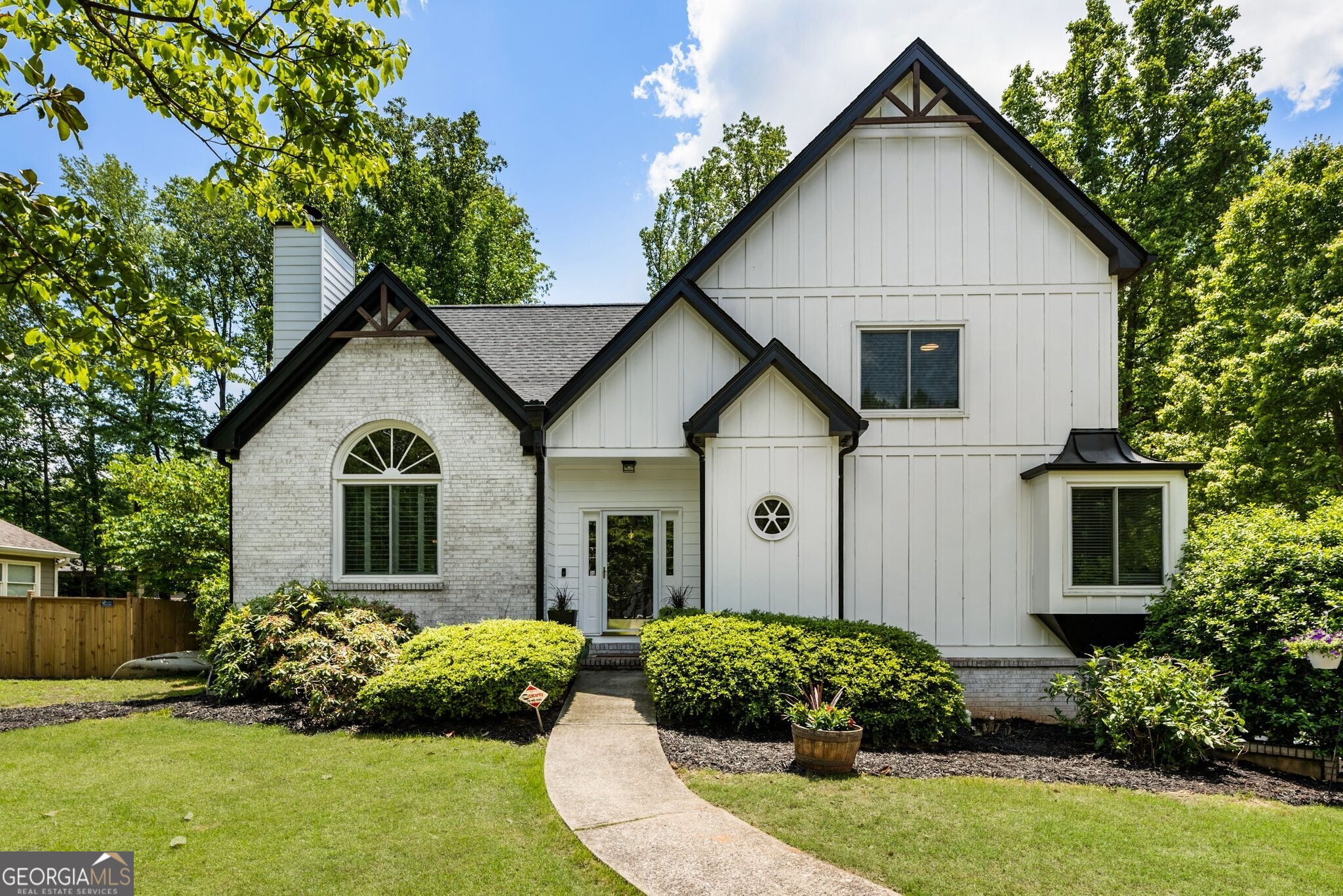 Charming, Fully Renovated Home Just Steps from Downtown Alpharetta! Welcome to 5600 Surrey Court, a beautifully updated gem nestled on a quiet cul-de-sac in the heart of Alpharetta, GA. With modern upgrades throughout and a walkable location to one of North Georgia's most vibrant downtowns, this home offers the perfect blend of comfort, convenience, and character. Boasting a brand-new roof, windows, HVAC, siding, and a whole-house water filtration system, this home is move-in ready and built to last. The primary suite on the main level provides unmatched comfort, while new hardwood floors, remodeled bathrooms, and modern lighting add a luxurious touch throughout. Step inside to a vaulted family room with a cozy fireplace, ideal for relaxing evenings or hosting friends. A flexible bonus space nearby can be used as an office, playroom, or den -tailored to fit your lifestyle. The updated kitchen features brand-new appliances and a sunny eat-in area, leading into a sunroom flooded with natural light - a perfect spot for morning coffee or quiet reading. From here, step out onto the spacious back deck that overlooks a fully fenced, flat backyard, ideal for pets, play, or peaceful outdoor living. Nature lovers will appreciate the large organic garden, established areas for grapes, elderberries, and wild blackberries, and a cozy firepit gathering area - your private oasis to enjoy Georgia's stunning sunrises and star-filled nights. But the location is what truly sets this home apart: Just a short stroll to Downtown Alpharetta, you'll enjoy live concerts, weekend festivals, boutique shops, and some of the city's best restaurants and food trucks-all without needing to drive. Walk to the farmers market, or catch an outdoor show just minutes from your front door! Additional features include: newly remodeled luxury primary bath, separate storage shed for tools and gear, unfinished basement with high ceilings and tons of potential, and flat lot perfect for a future carriage house or detached garage, This is your chance to own a home that offers both serenity and connection, style and substance - all in one of Alpharetta's most desirable locations. Don't miss out - schedule your private tour today and experience life at 5600 Surrey Court!