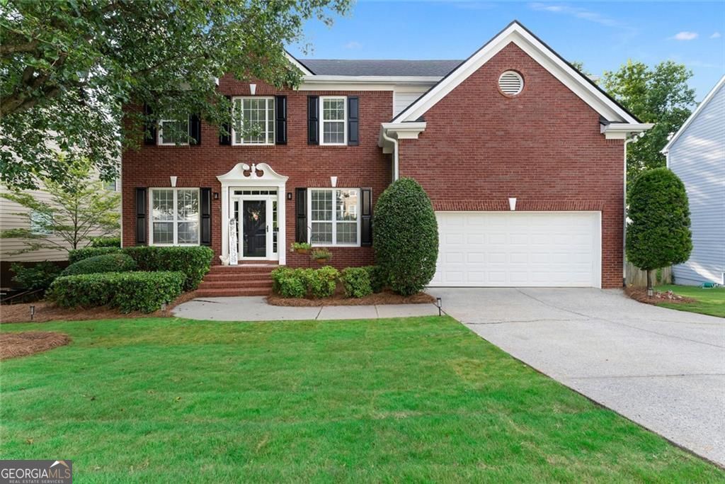 Brilliance, Boldness, and Beauty define this 6-bedroom, 3.5-bath stately home in McEver Woods. With a timeless brick front, welcoming front porch, fresh landscaping, and newly painted exterior, makes a stunning first impression. Step inside to a spacious, open floor plan with fresh paint and cascading wide plank flooring throughout the main level. A large flex room currently a home office sits just off the entry, while a wonderfully formal dining room is ready for unforgettable holiday gatherings. The inviting family room, complete with a cozy fireplace, flows seamlessly into the distinguished kitchen featuring stainless steel appliances, quartz countertops, tiled backsplash, brushed gold accents, with handsome recessed and pendant lighting, and a custom island with seating. A main level bedroom (currently a playroom) offers the perfect guest space with nearby bath access. Upstairs, find a loft area which gives way to the expansive owner's suite that makes a bold statement to include a sitting area, spa-like bath with eye catching tiled flooring, soaking tub, frameless tiled shower, double vanities, custom cabinetry, and a vast walk-in closet with it's own closet system. Three additional bedrooms share a full bath with double vanities and tiled tub/shower combo with striking tile flooring. The fully finished basement with its own entrance features a bedroom, full bath with tiled walk-in shower, and plenty of space for the perfect secondary living quarters or the best game room. Out back, enjoy a cozy fire pit that warms any seasonal night, in fenced yard, with property extending beyond fence for even more outdoor possibilities. To complete this stately property, included A 7-Star Upgrade Home Warranty which provides added peace of mind. Welcome Home!