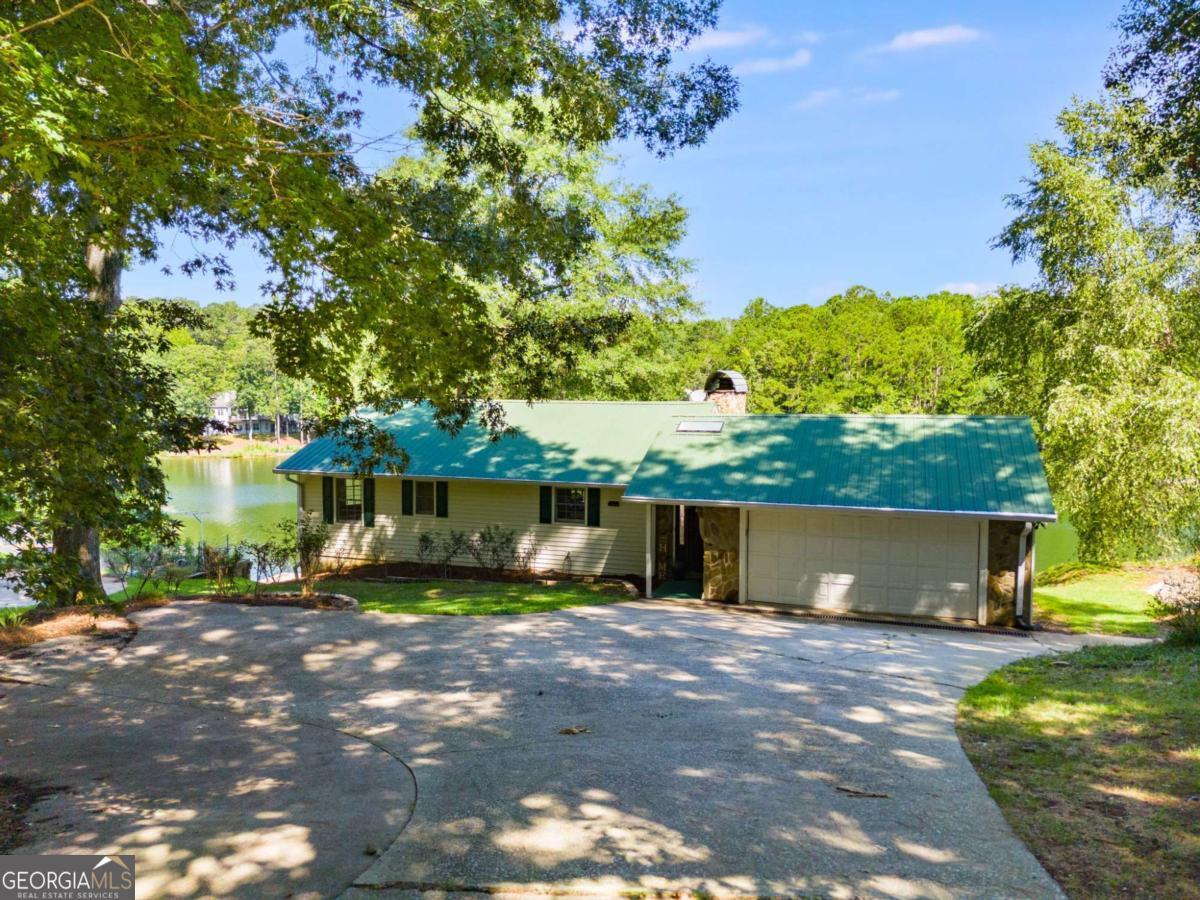 Stunning lake views in a gated community. This beautiful 3 bedroom, 2 bath home offers breathtaking lake views from every room, providing a tranquil backdrop to daily life. Located in a desirable gated community, the home features an open floor plan, perfect for entertaining. The main level boasts a spacious family room with a cozy fireplace, two generously sized bedrooms, and a large screened porch to enjoy the outdoors year-round. The finished basement provides even more space, with a large bedroom featuring a walk-in closet, a cozy den with its own fireplace, and a door leading to a walkout terrace with a spacious patio with the most amazing view of the lake. There is also a flex space that could be a perfect office, gym, game room, whatever you want to make it. Located in the amenity-packed Fairfield Plantation, this home offers access to two lakes, including a BEACH, two swimming pools, 3 lighted tennis courts, pickleball courts, a golf course, hiking trails, and a recreation center featuring a game room, a workout facility, and more. Enjoy year-round dining at the clubhouse or marina restaurant in this gated community with 24-hour security. A true retreat in a private setting!