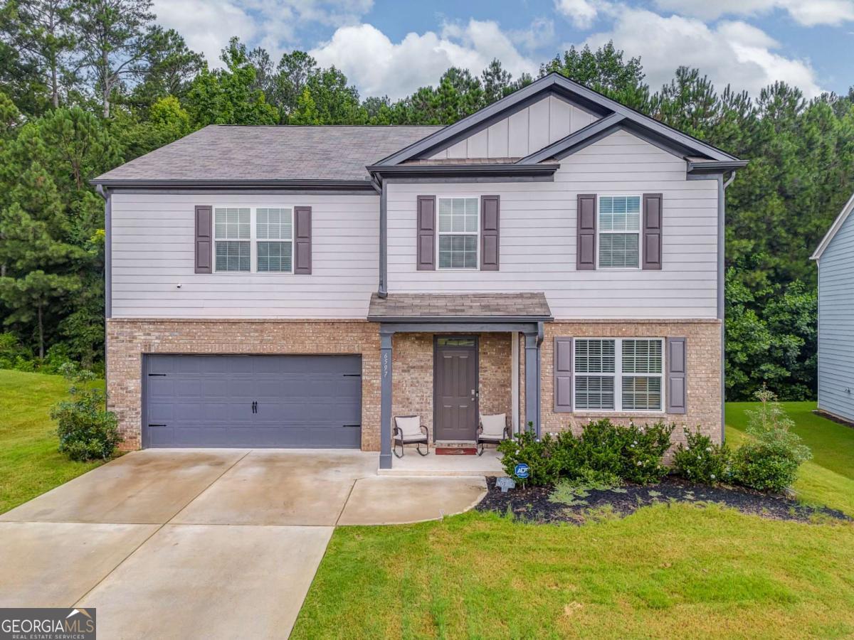 Located in the desirable Gateway Village Subdivision, this spacious 5-bedroom, 3-bathroom home features an open-concept floor plan perfect for modern living. The eat-in kitchen offers a large island, ample cabinetry, and a walk-in pantry, seamlessly flowing into the main living and dining areas. Upstairs, a generous loft provides additional living space-ideal for a media room or home office. The oversized master suite includes a sitting area, dual walk-in closets, his and hers vanities, a soaking tub, and a separate shower for a true spa-like retreat. Enjoy the convenience of being close to the community clubhouse, pool, and recreation areas. Located just minutes from Arbor Place Mall, Sweetwater Creek State Park, and the dining and community charm of historic downtown Douglasville.